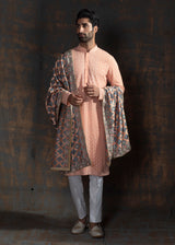 Rustish orange embroidered kurta paired up with ivory pant pajama.