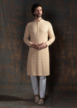 Beige embroidered kurta paired up with ivory pant pajama.