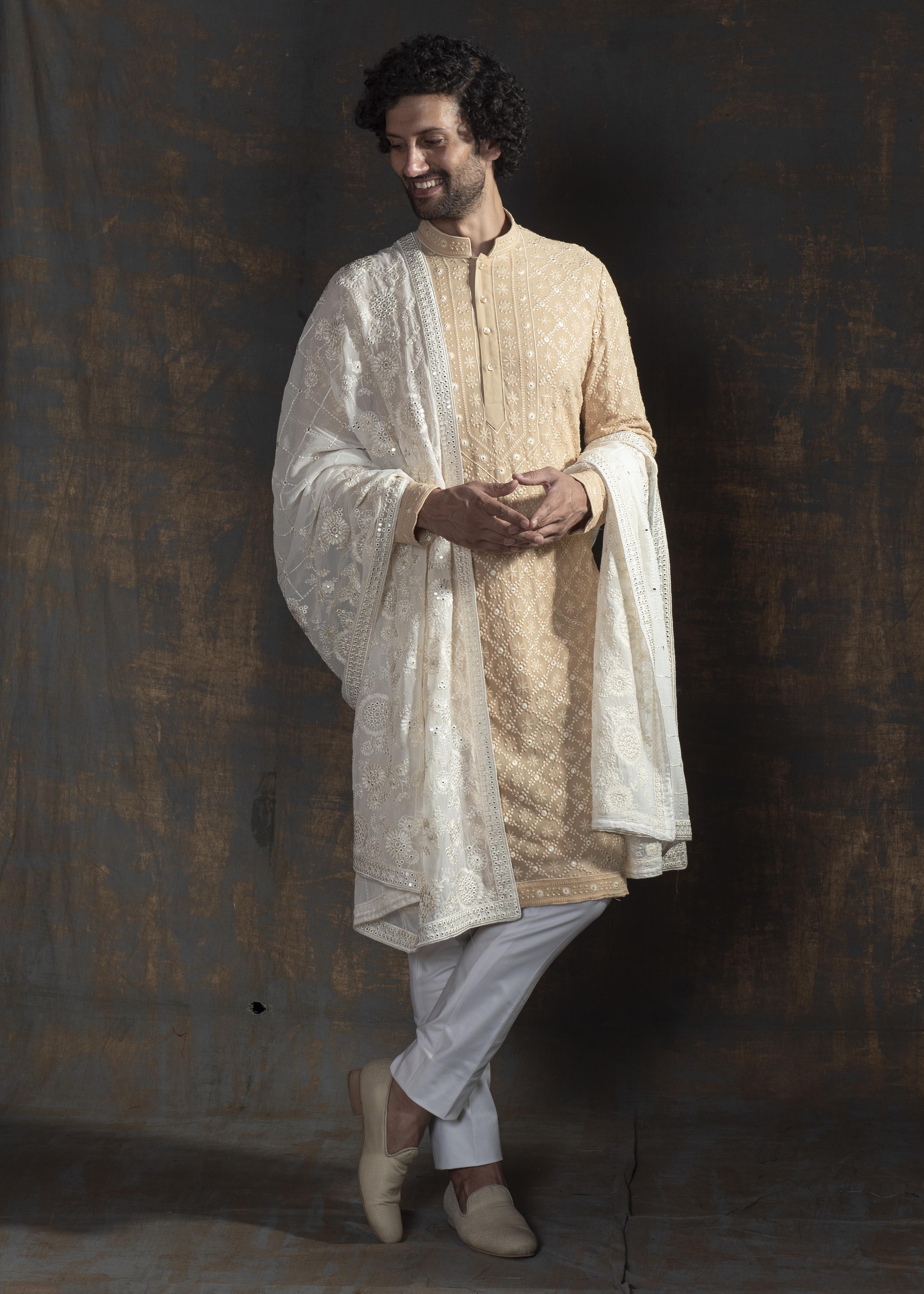 Beige embroidered kurta paired up with ivory pant pajama.