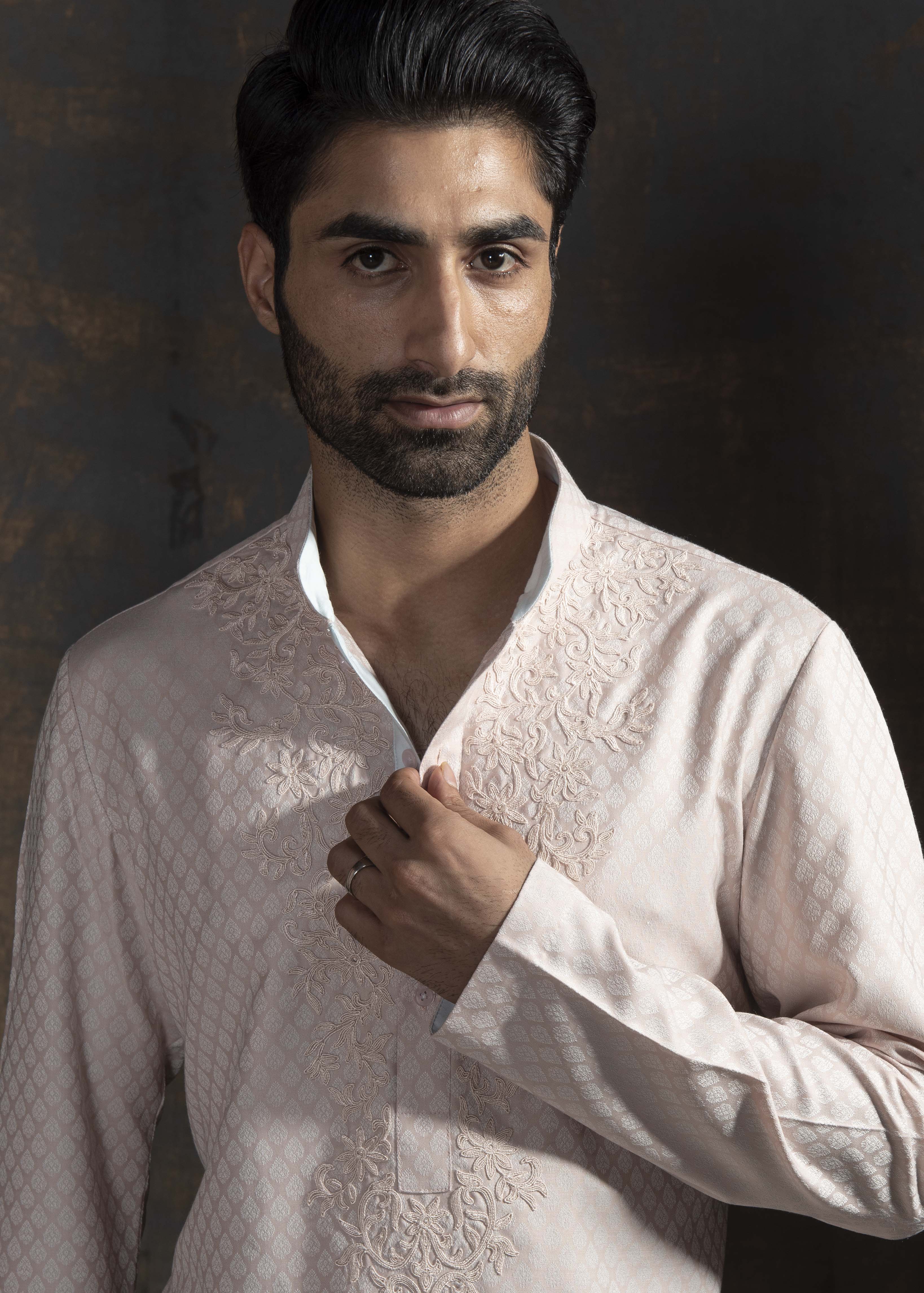 Pink self printed kurta with ivory embroidery on the neck. Paired up with ivory pant cut pajama.