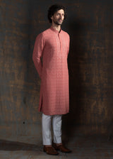 Rust coloured embroidered kurta.  Paired up with ivory pant cut pajama.
