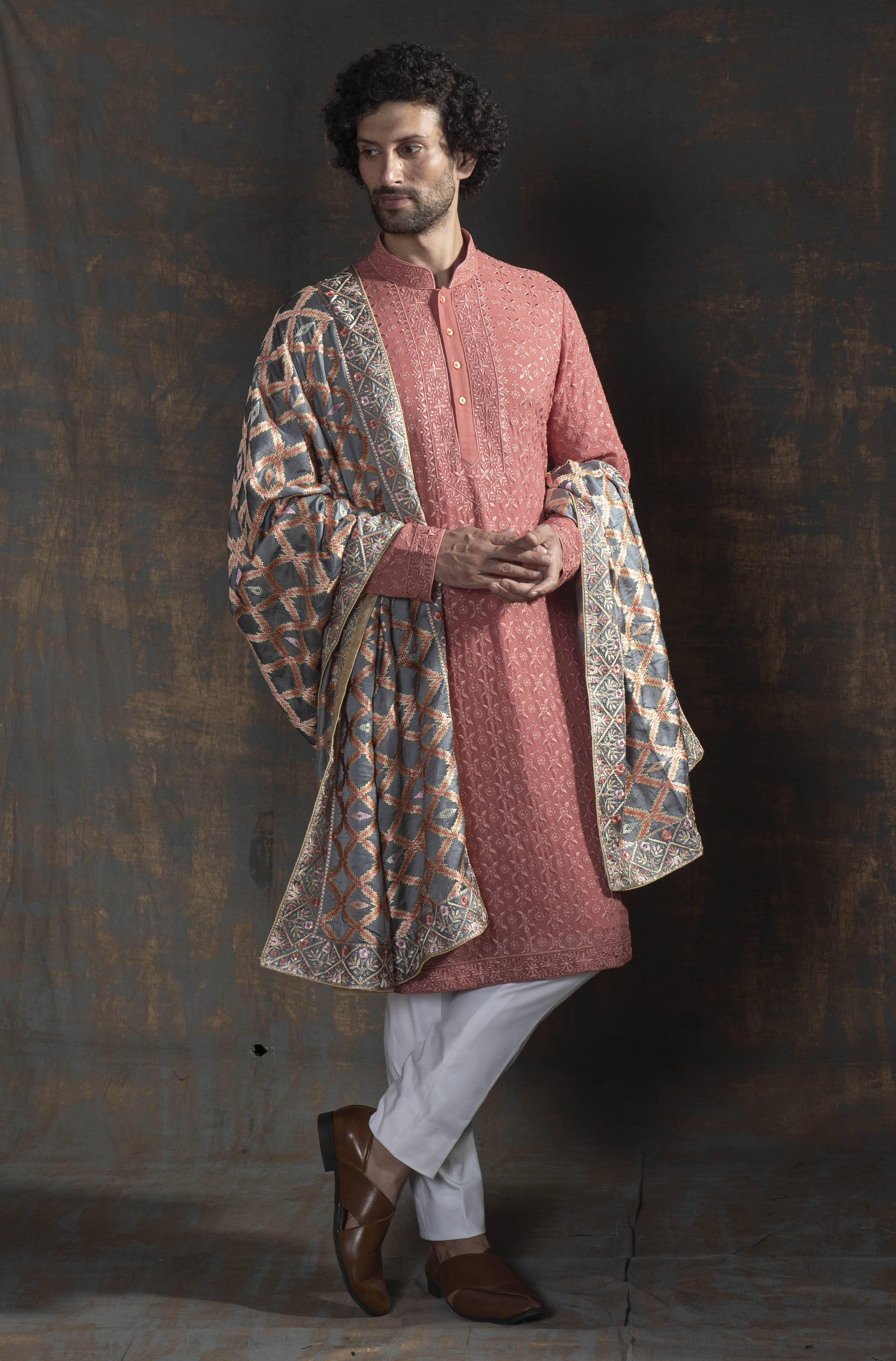 Rust coloured embroidered kurta.  Paired up with ivory pant cut pajama.