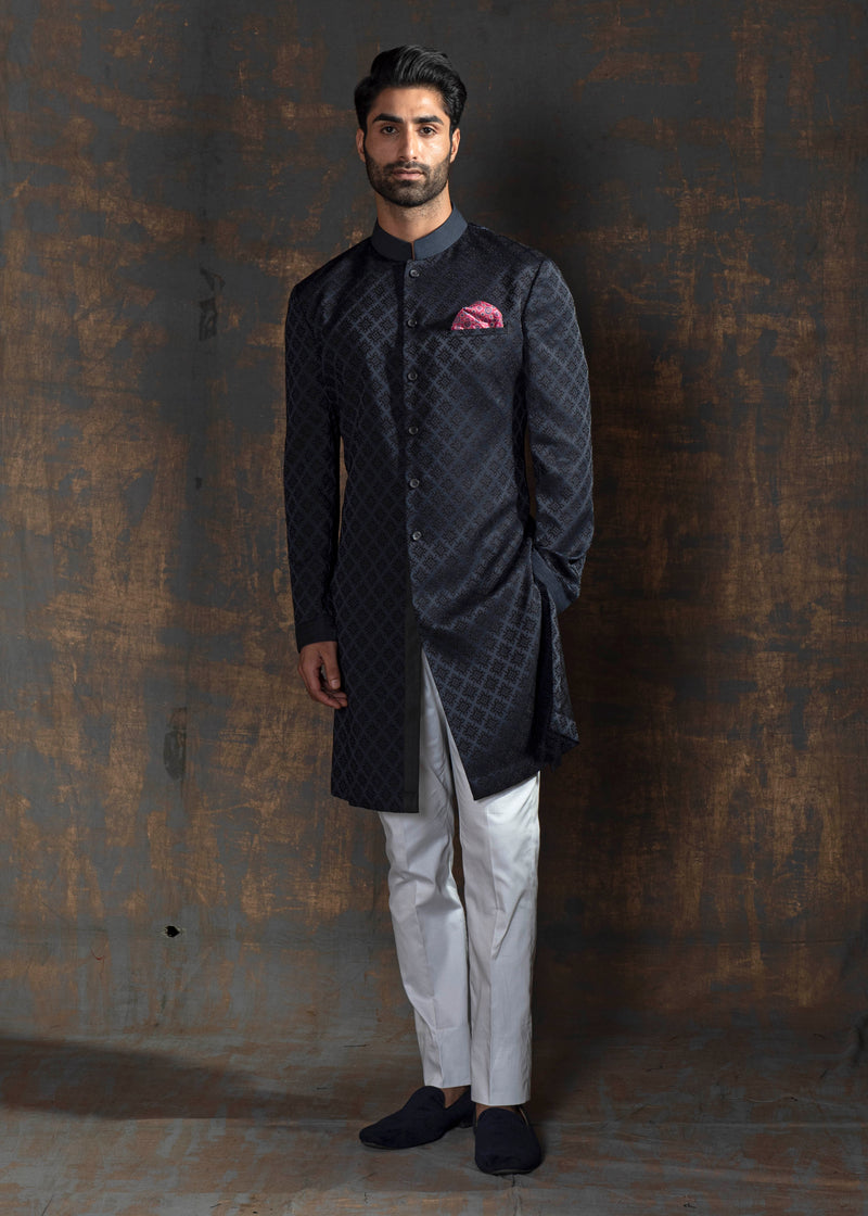 Blue self embroidered indo western with off white pants.