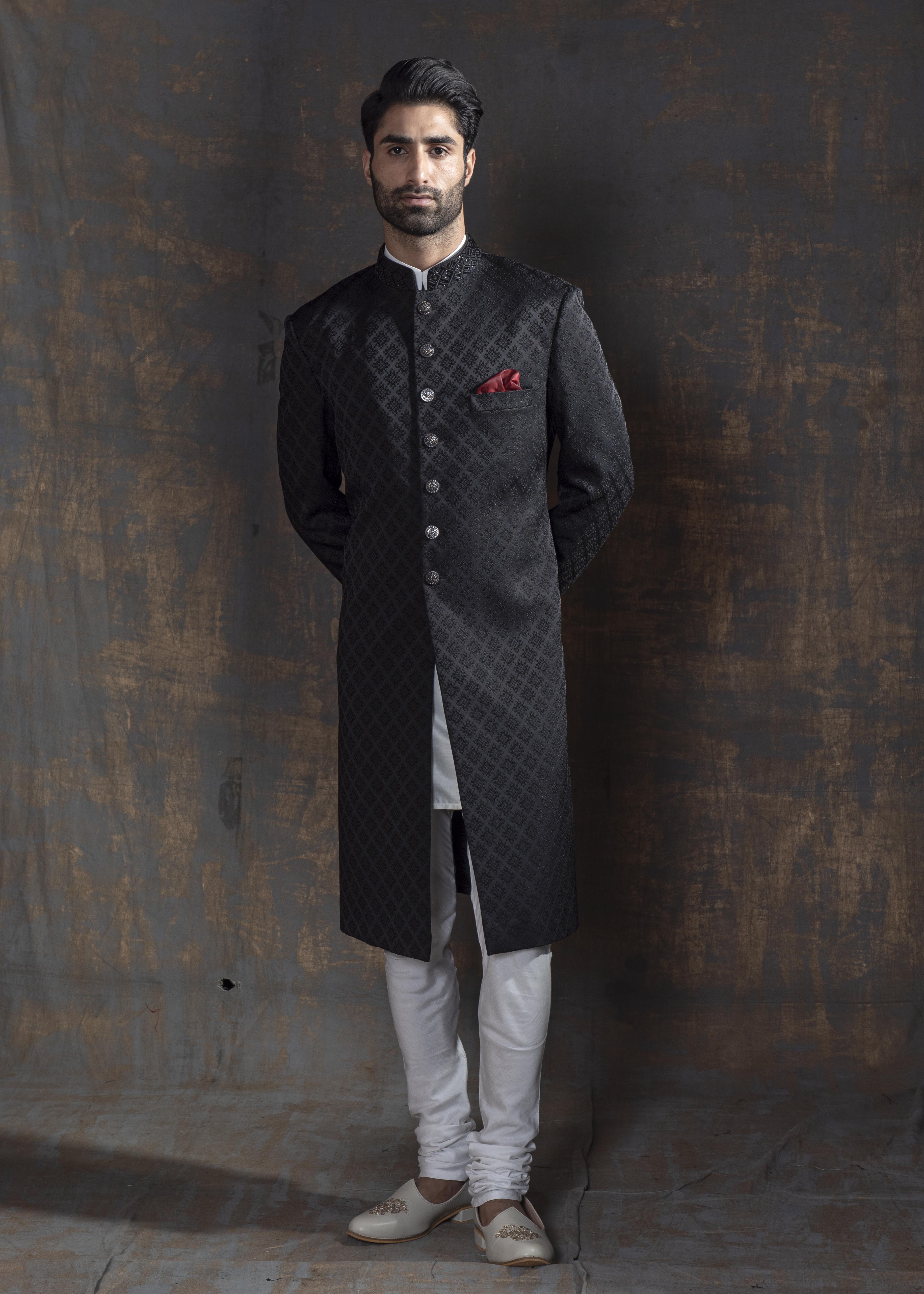 Black self embroidered achkan with off white kurta and pajama.