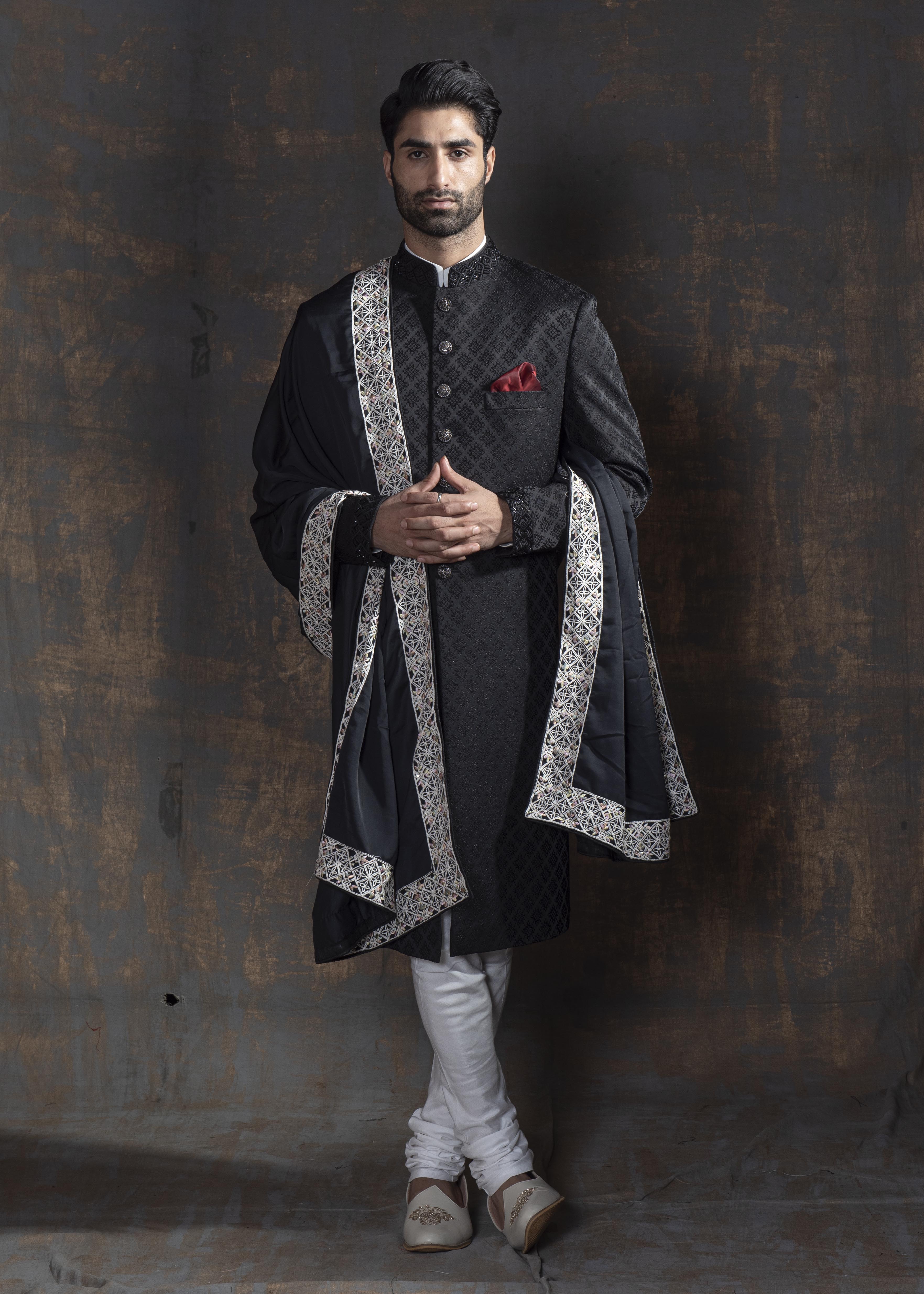 Black self embroidered achkan with off white kurta and pajama.