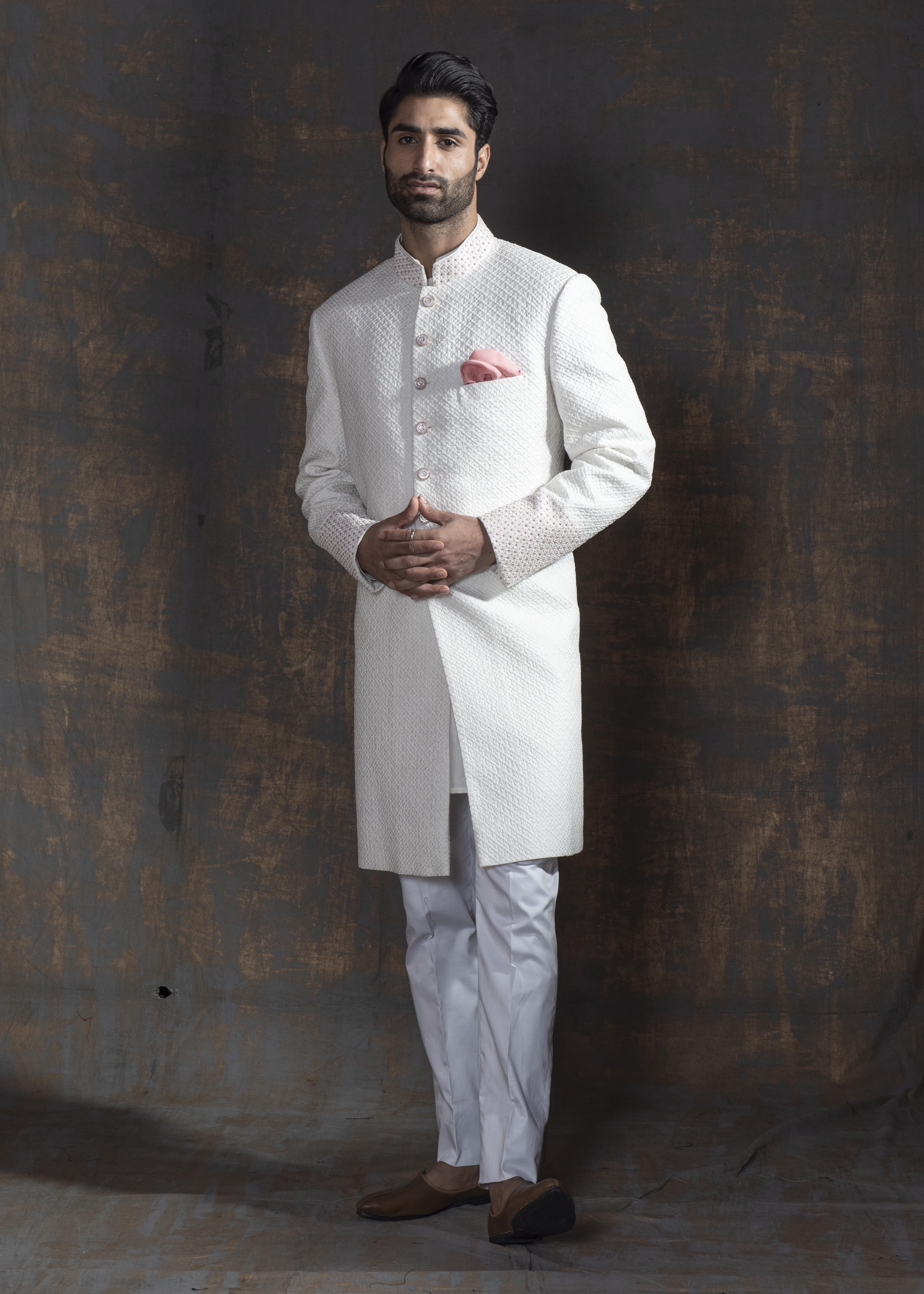 White self embroidered sherwani with off white kurta pajama.