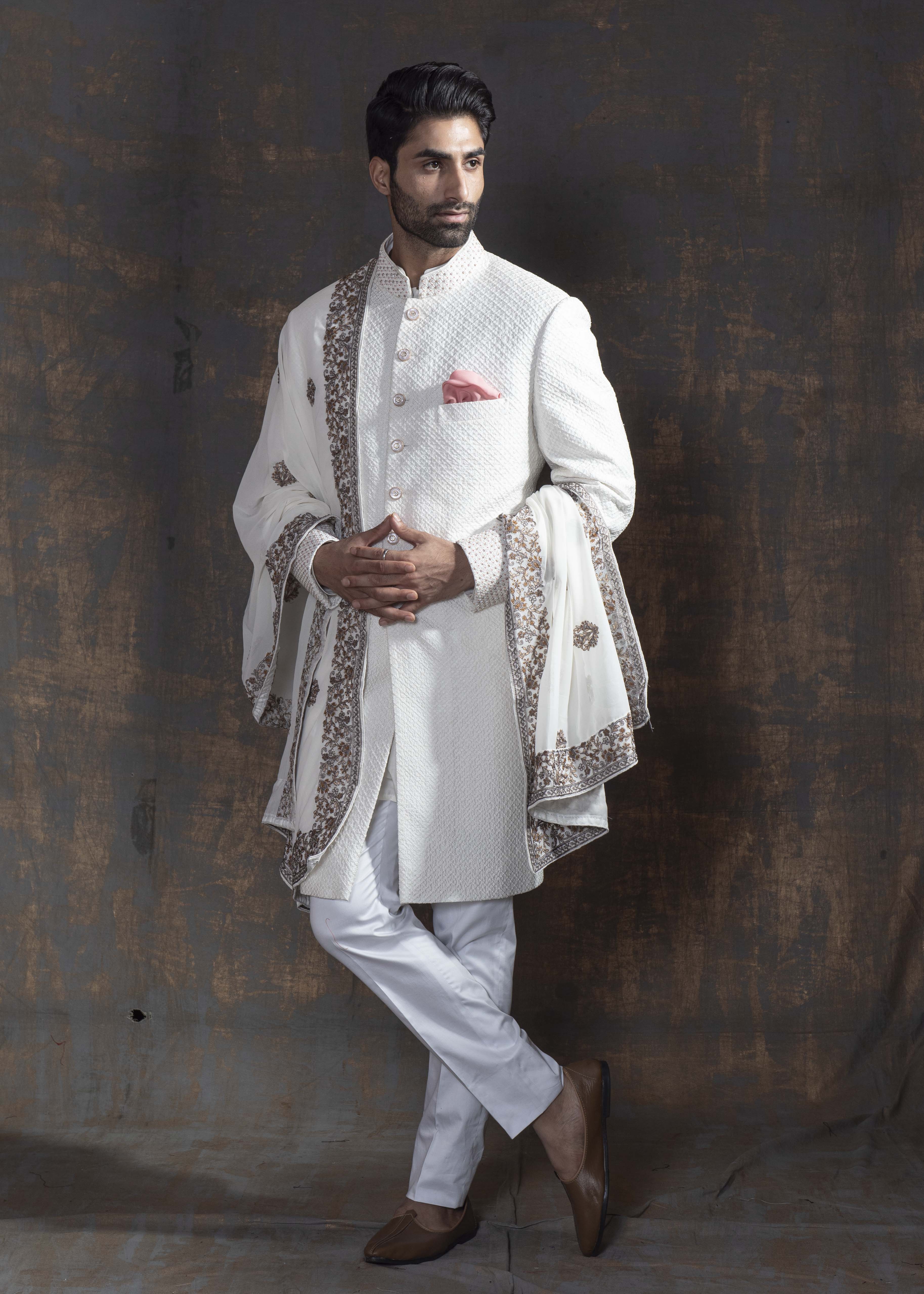 White self embroidered sherwani with off white kurta pajama.