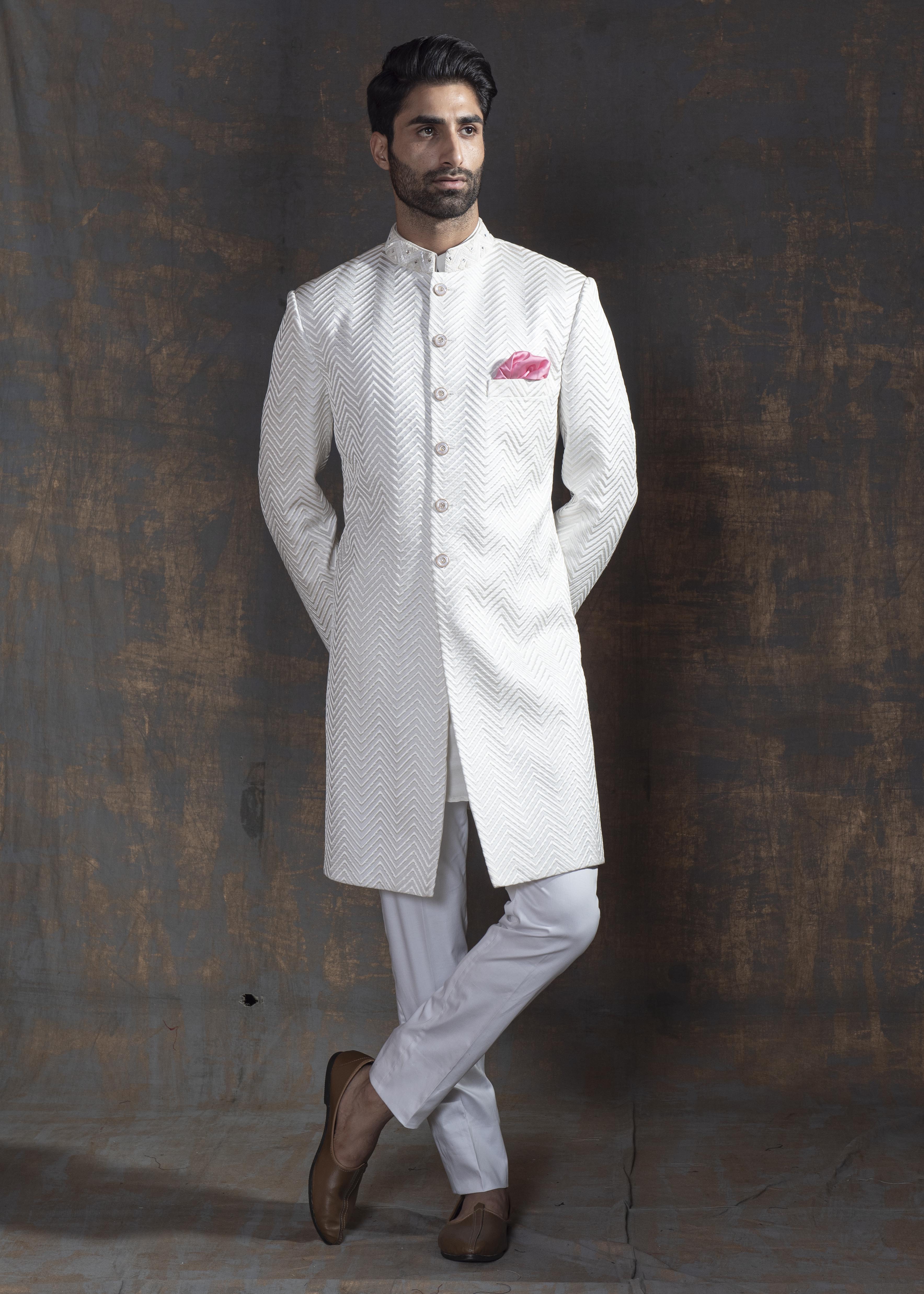 Ivory Pintuck achkan. Paired up with off white kurta pajama.