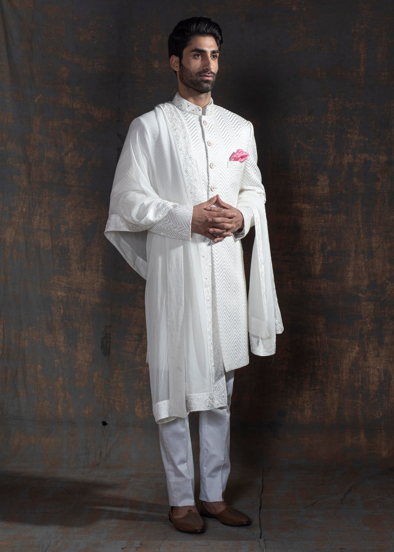Ivory Pintuck achkan. Paired up with off white kurta pajama.