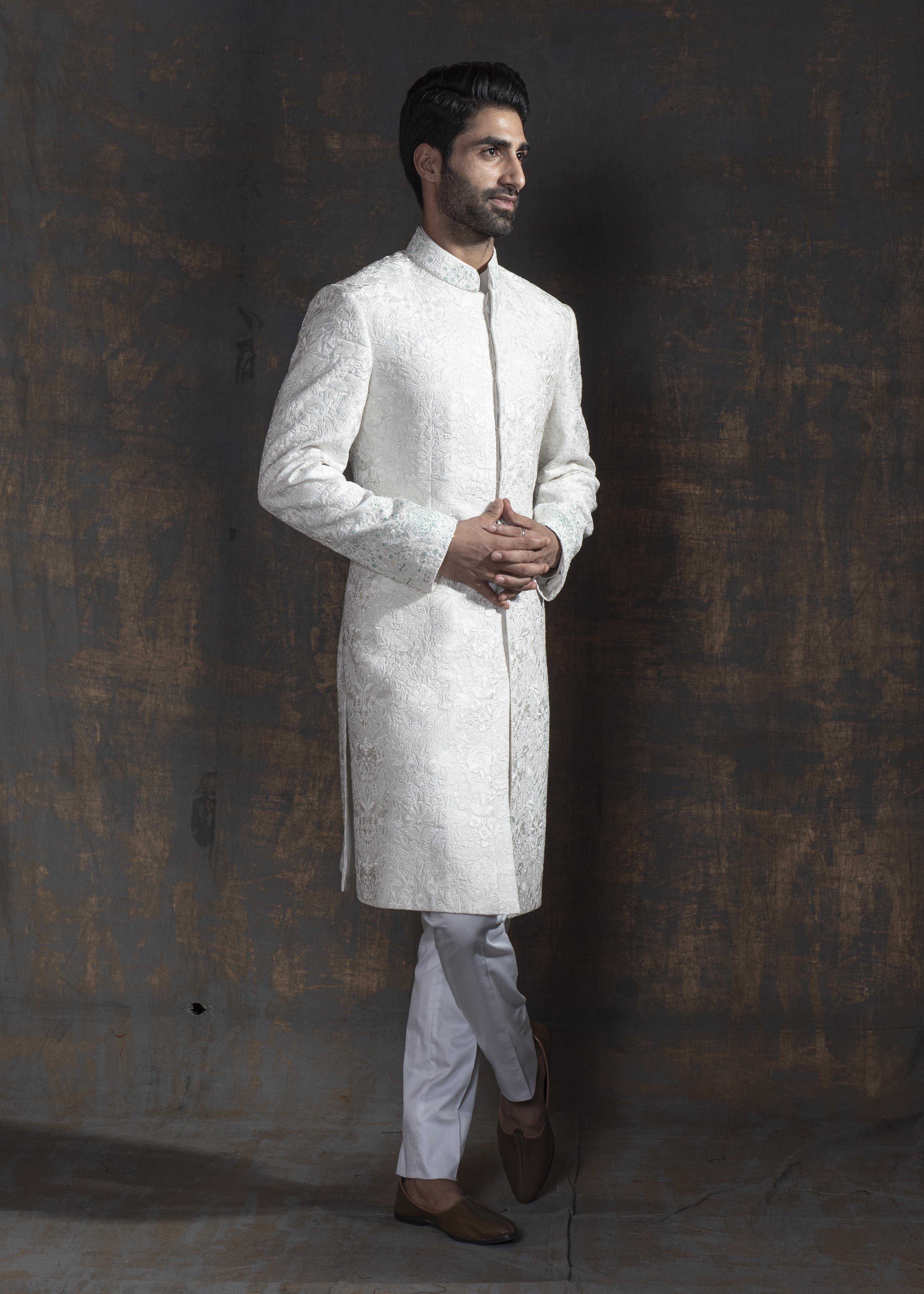 White self embroidered sherwani with off white kurta pajama.