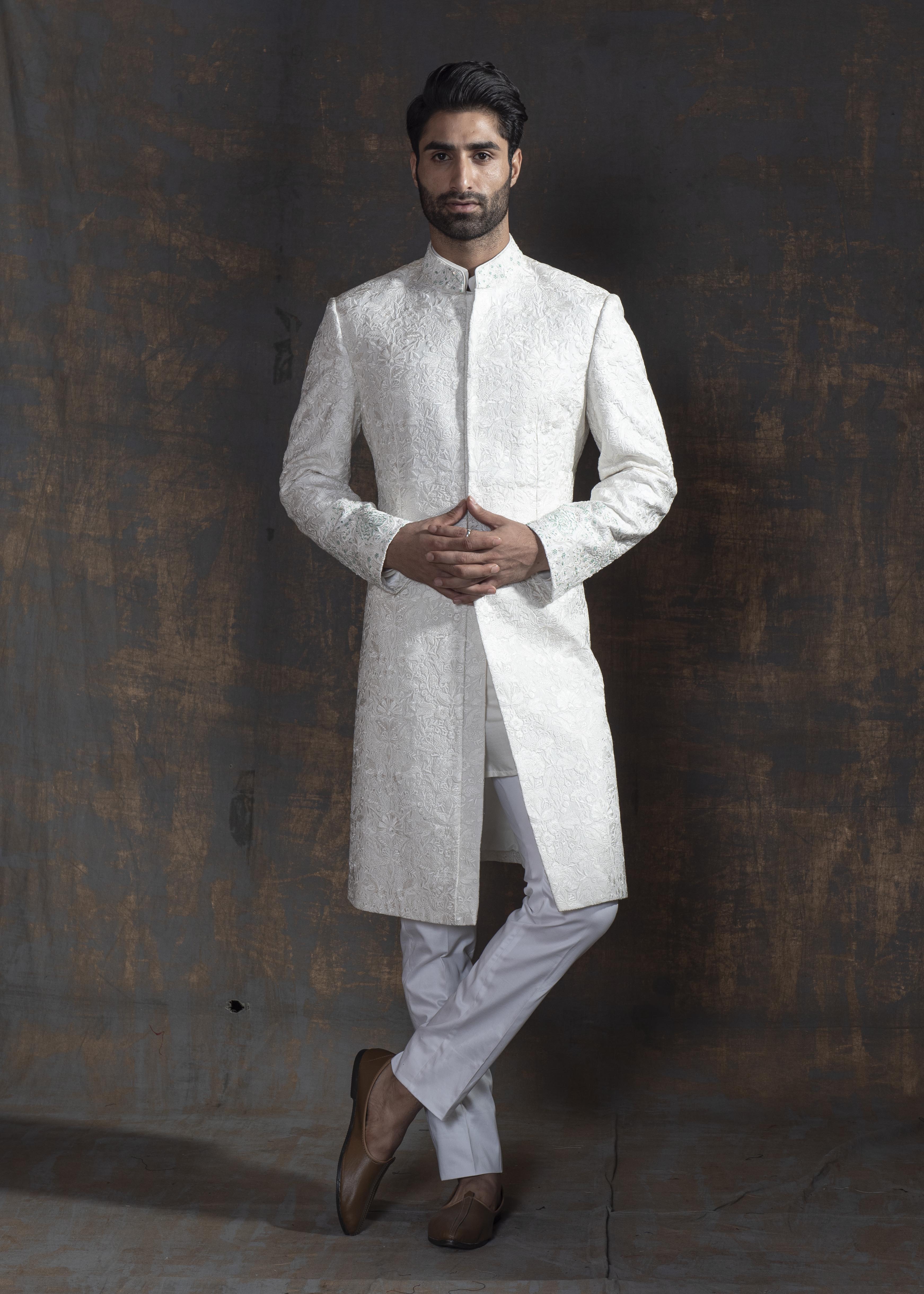 White self embroidered sherwani with off white kurta pajama.