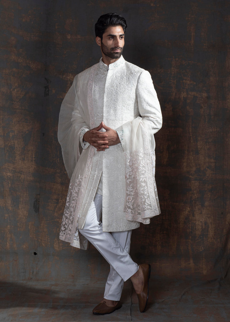 White self embroidered sherwani with off white kurta pajama.