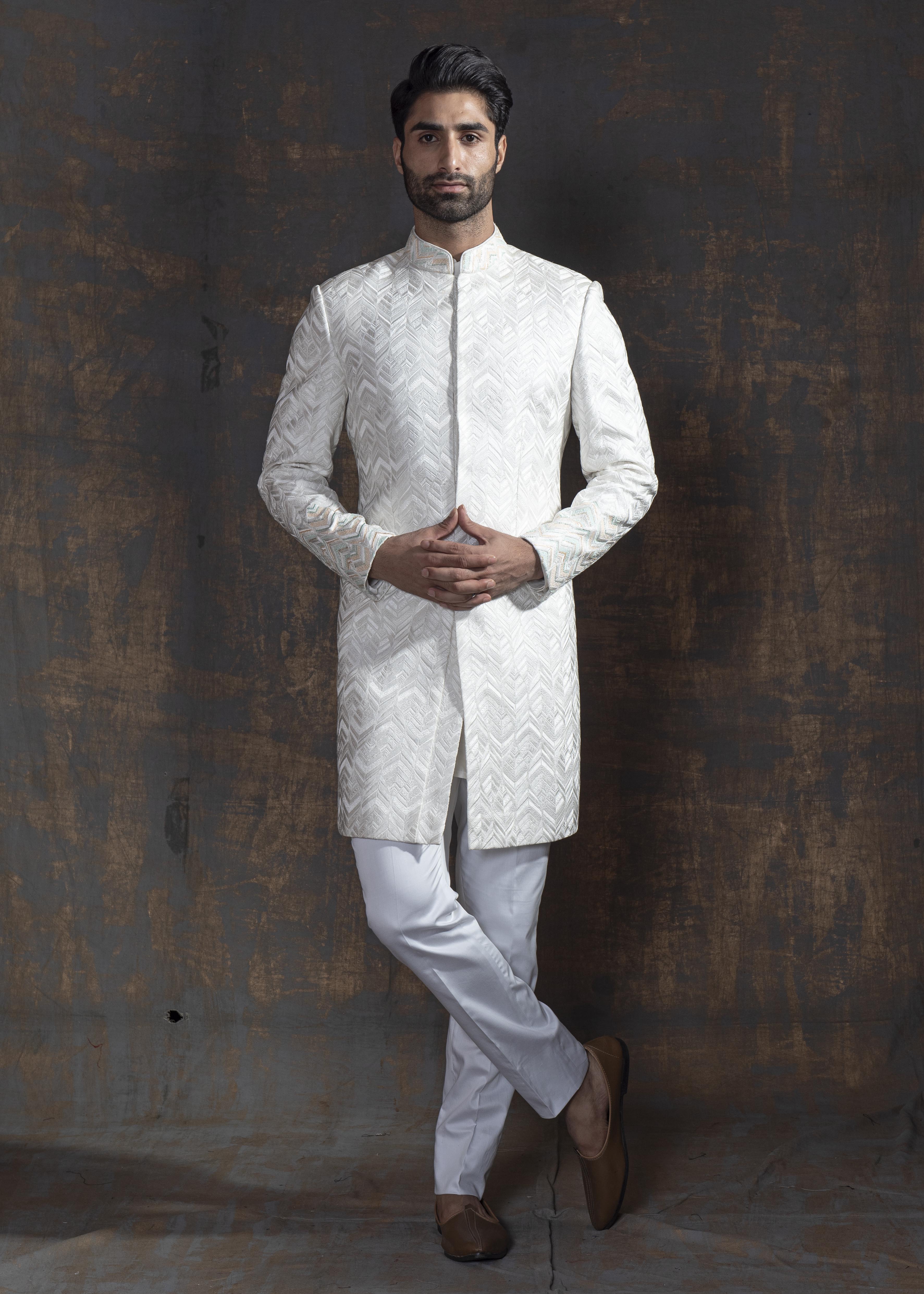 White self embroidered sherwani with off white kurta pajama.