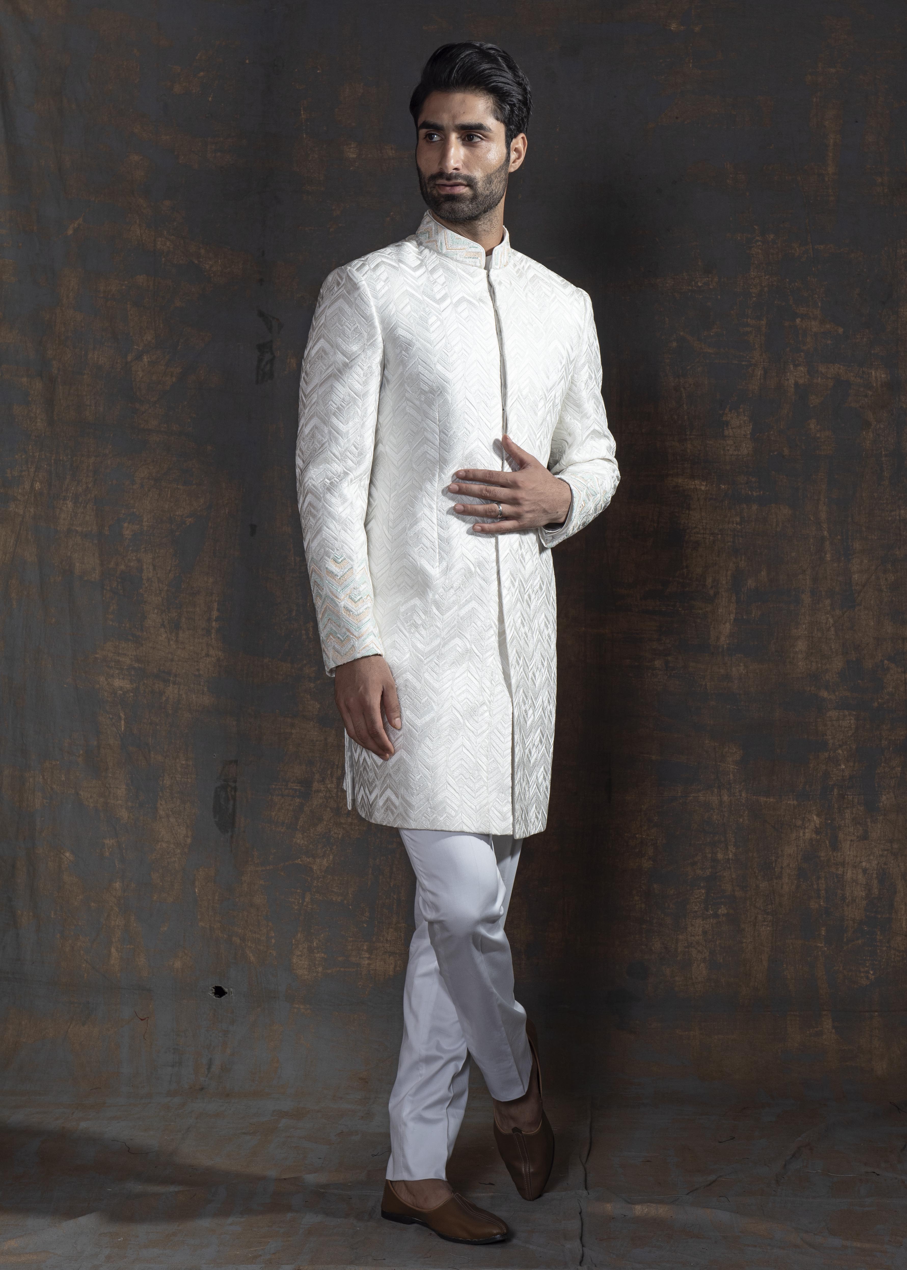 White self embroidered sherwani with off white kurta pajama.