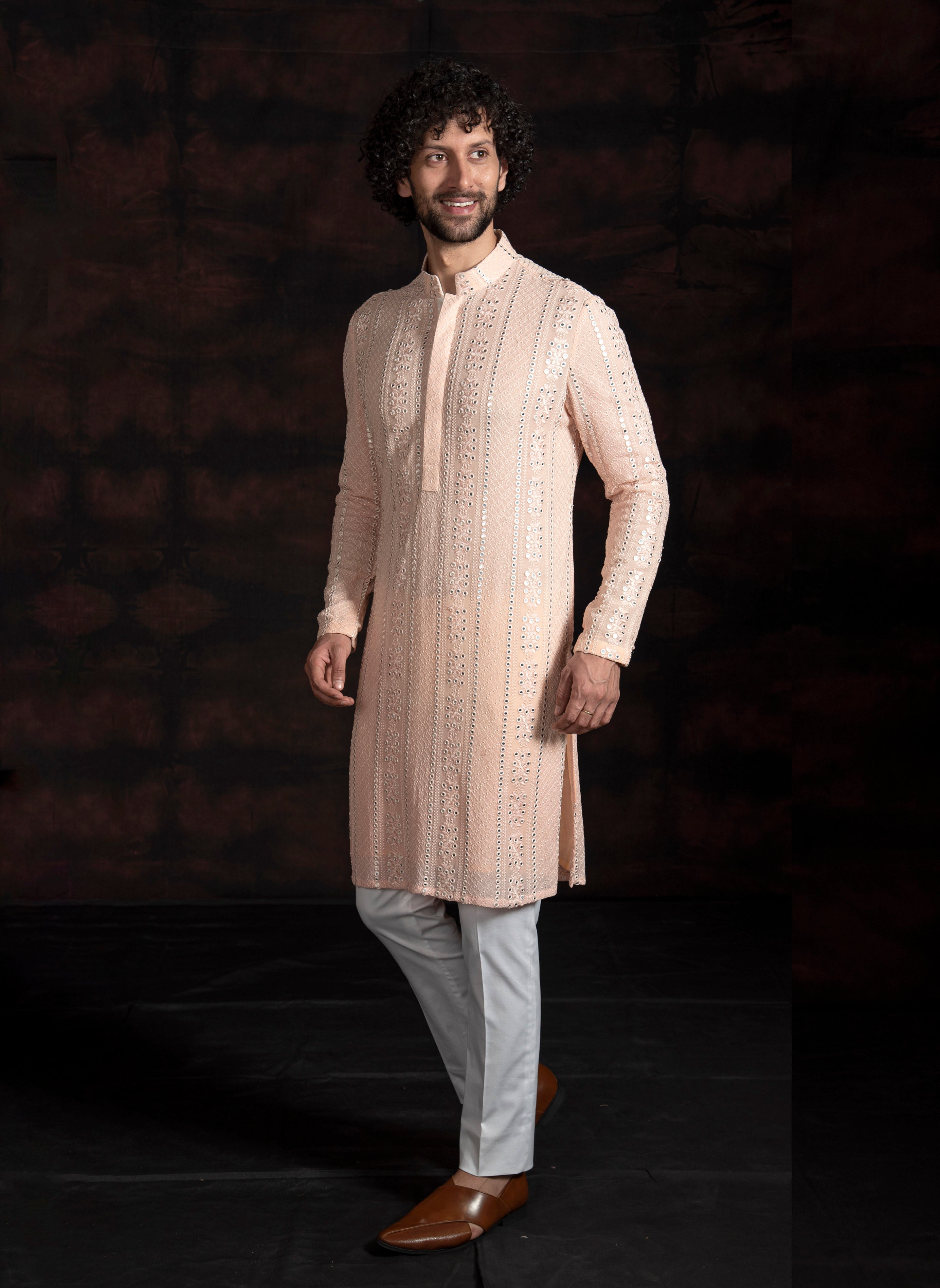 Peach mirror work kurta with ivory pant cut pajama.