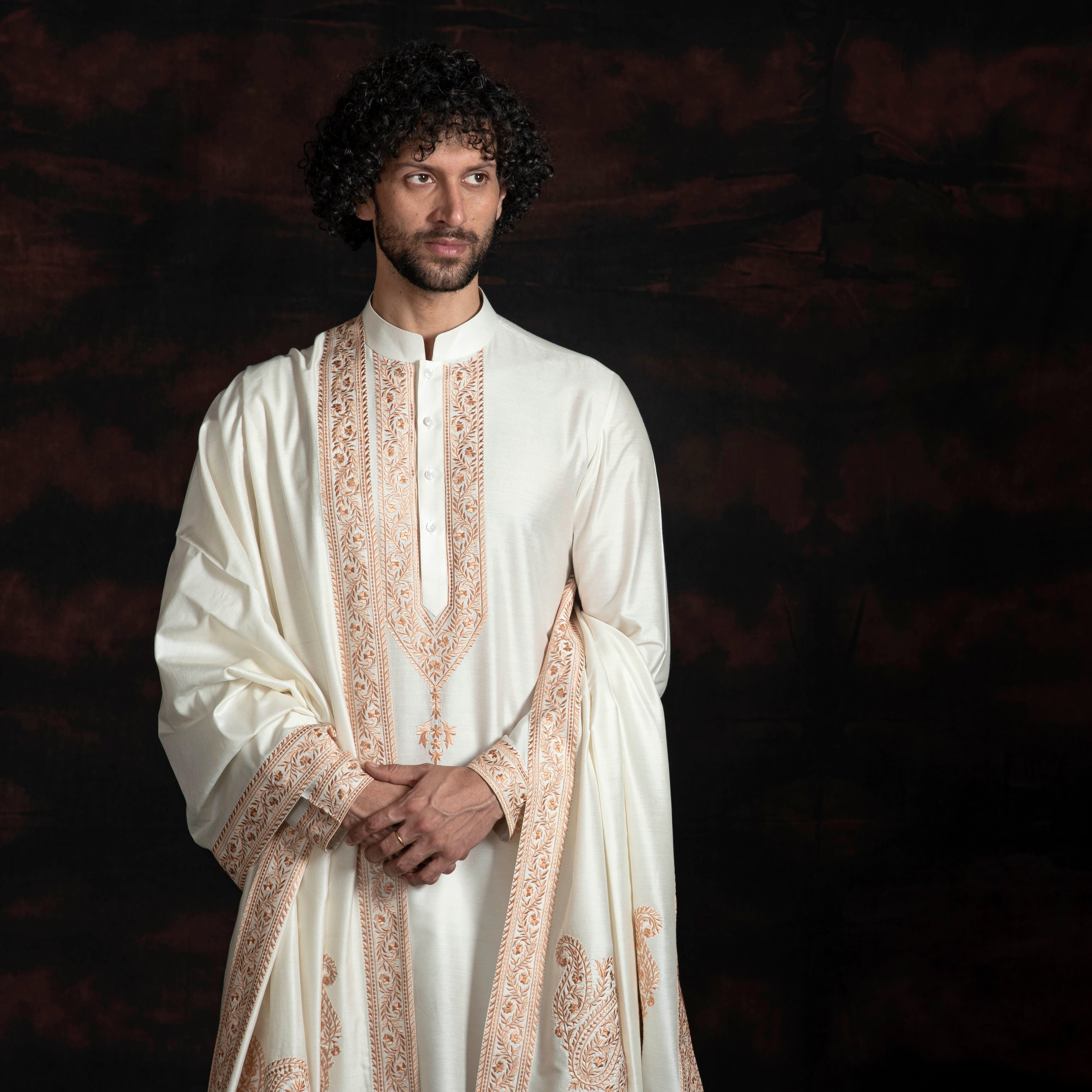 Cream coloured kurta with faun coloured embroidery and same coloured stole with the same embroidery.