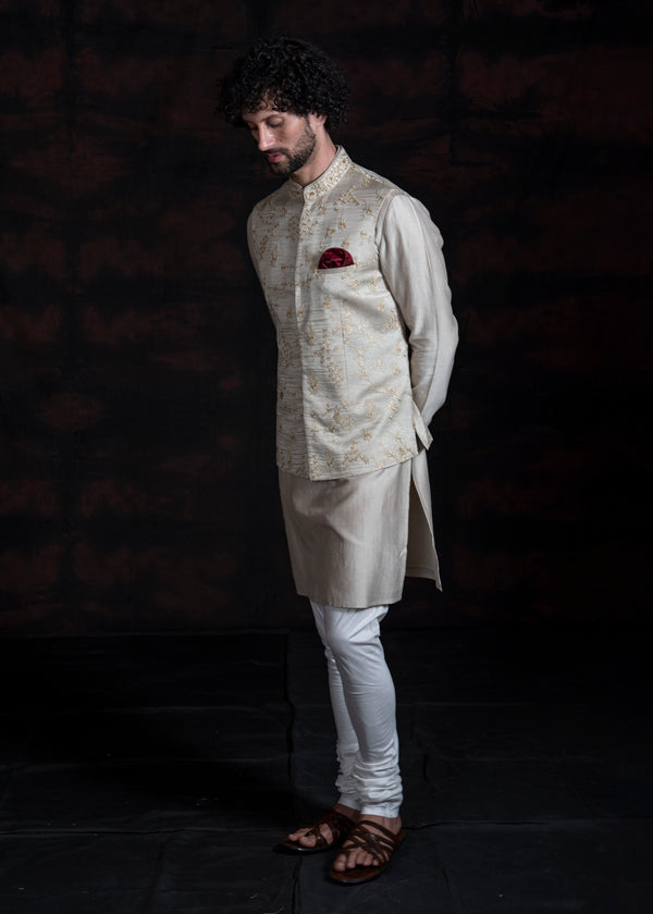 Light champagne nehru jacket with floral embroidery with silk kurta and pajama.