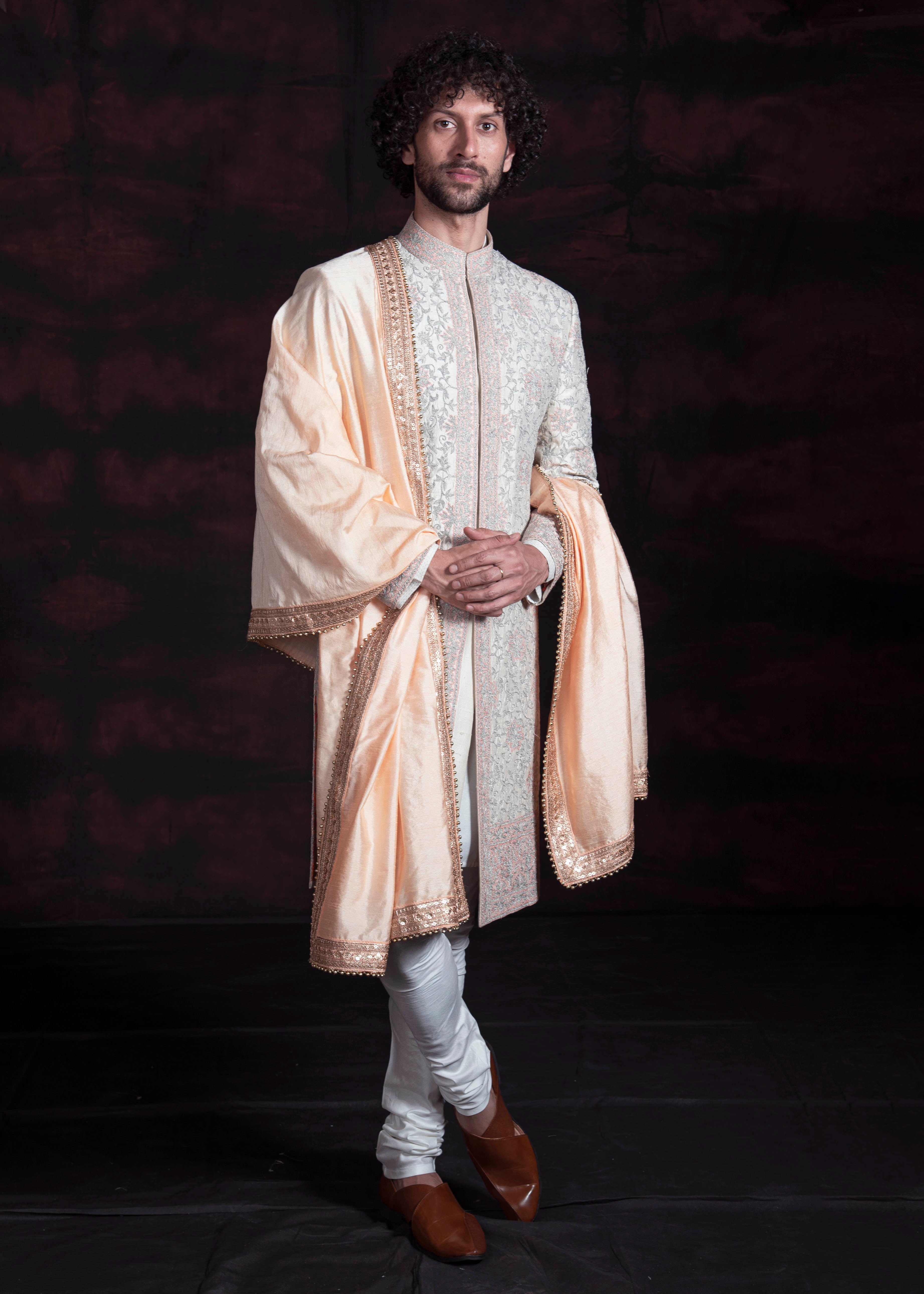 Ivory sherani with solver grey zari embroidery and peach thread embroidery.