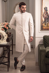 Ivory self embroidered sherwani with off white kurta pajama.