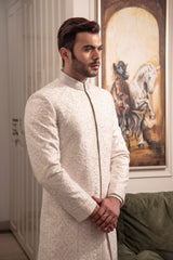 Ivory self embroidered sherwani with off white kurta pajama.