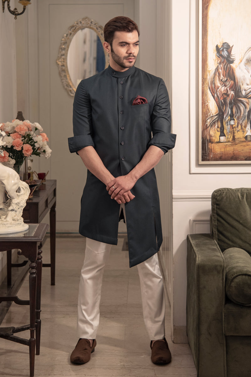 Charcoal grey designer indo cut kurta with asymmetrical cuts. Paired up with ivory pants.