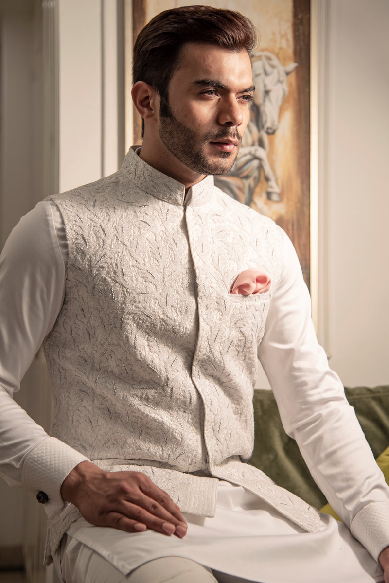 White embroidered nehru jacket with off white kurta pajama.
