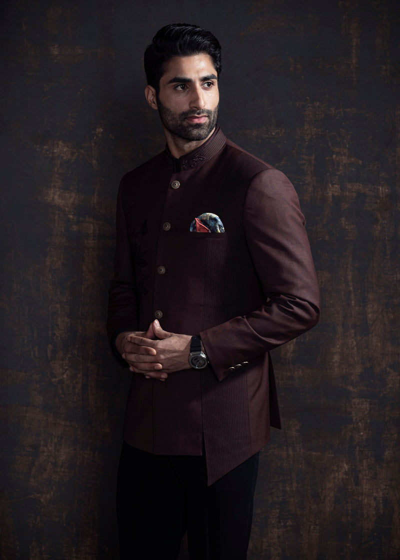 Brown designer, asymmetrical bandgala jacket with black vertical thread work and self on self embroidery. Paired up with jet black pants.