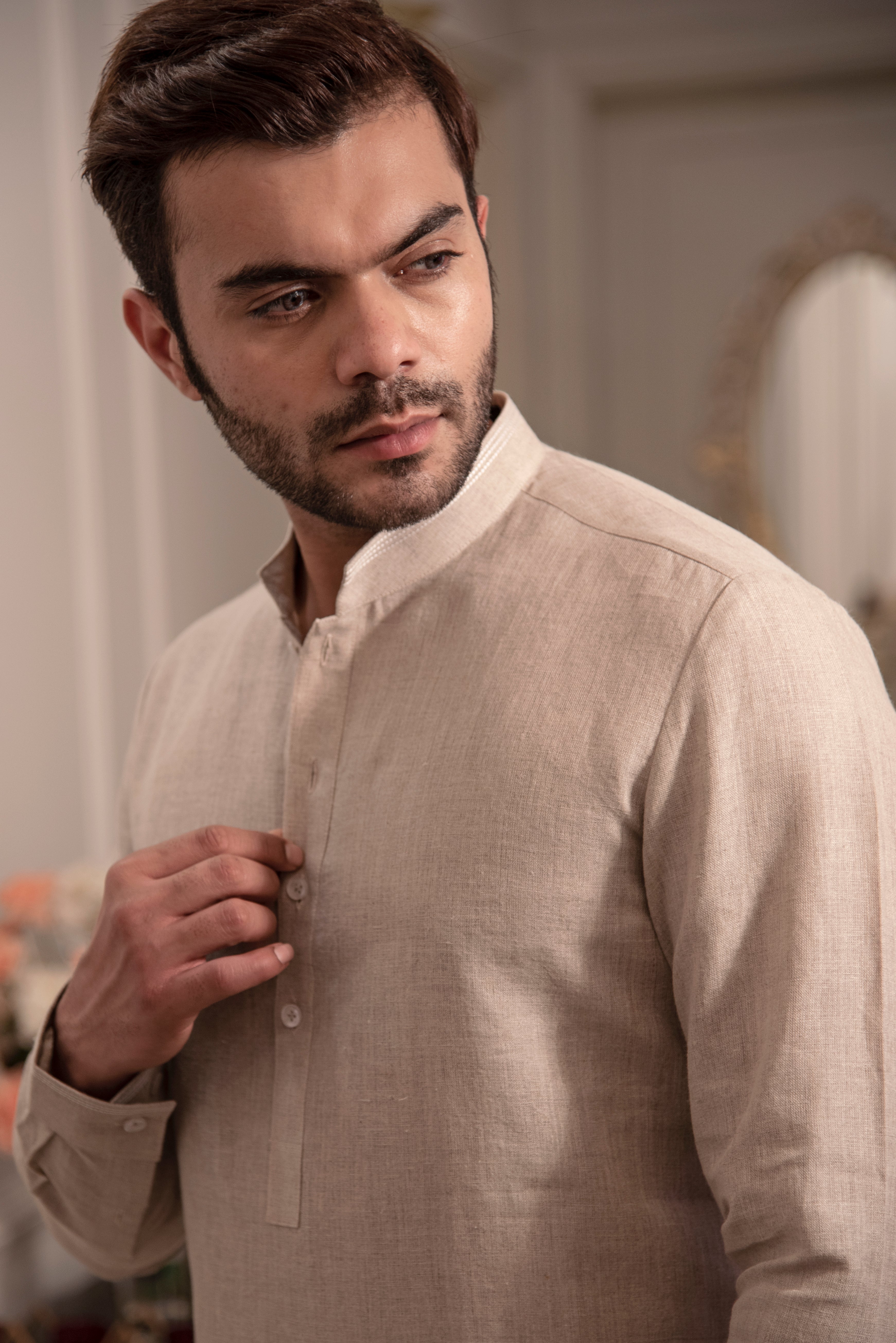 Beige linen kurta with ivory pants.