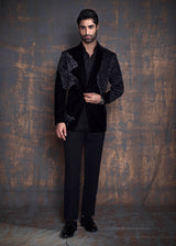 Black cotton velvet tuxedo jacket with animal embroidery. Paired up with jet black pants.