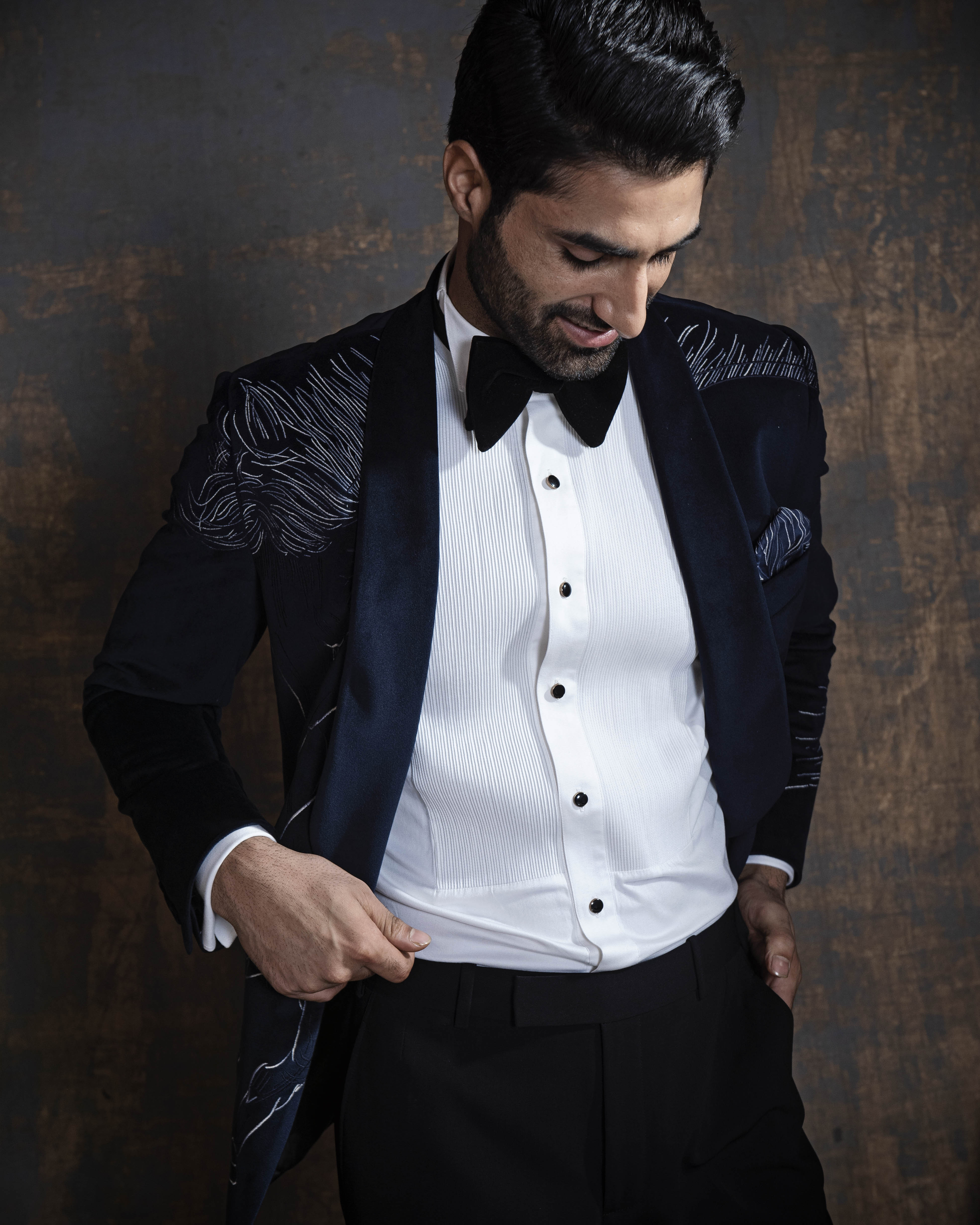 Blue velvet tuxedo with animal embroidery. Paired up with jet black pants.