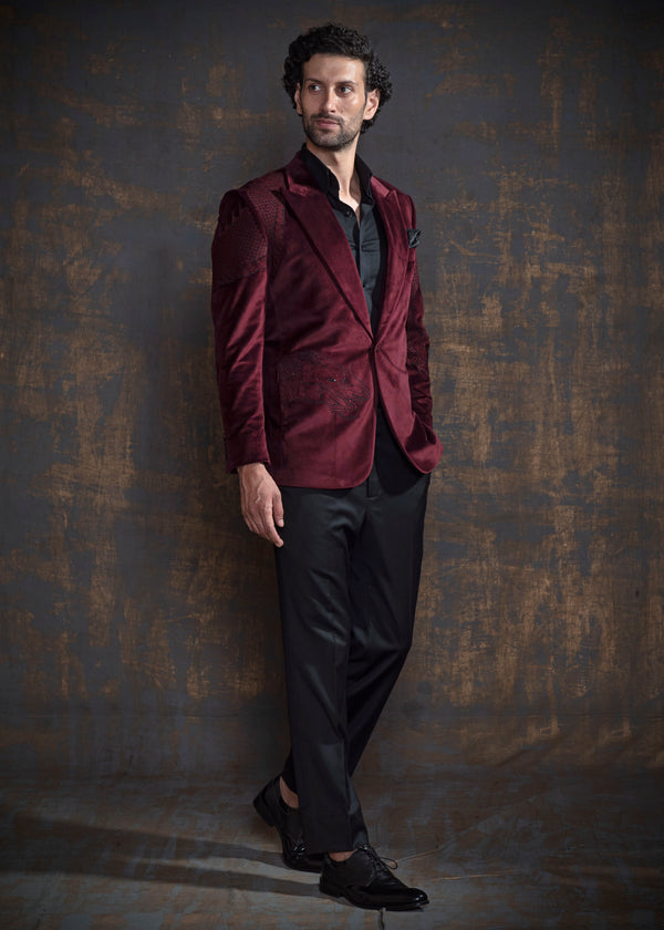 Deep red velvet tuxedo with animal embroidery.  Paired up with jet black pants.