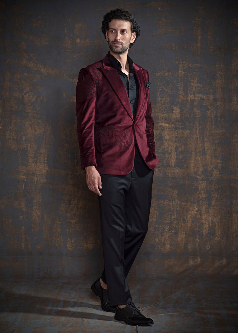 Deep red velvet tuxedo with animal embroidery.  Paired up with jet black pants.
