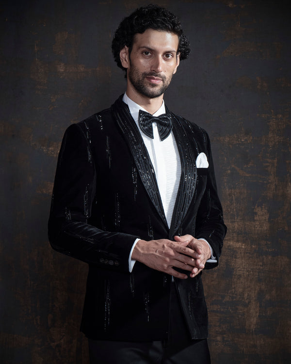 Black cotton velvet tuxedo jacket with hand embroidery. Paired up with jet black pants.