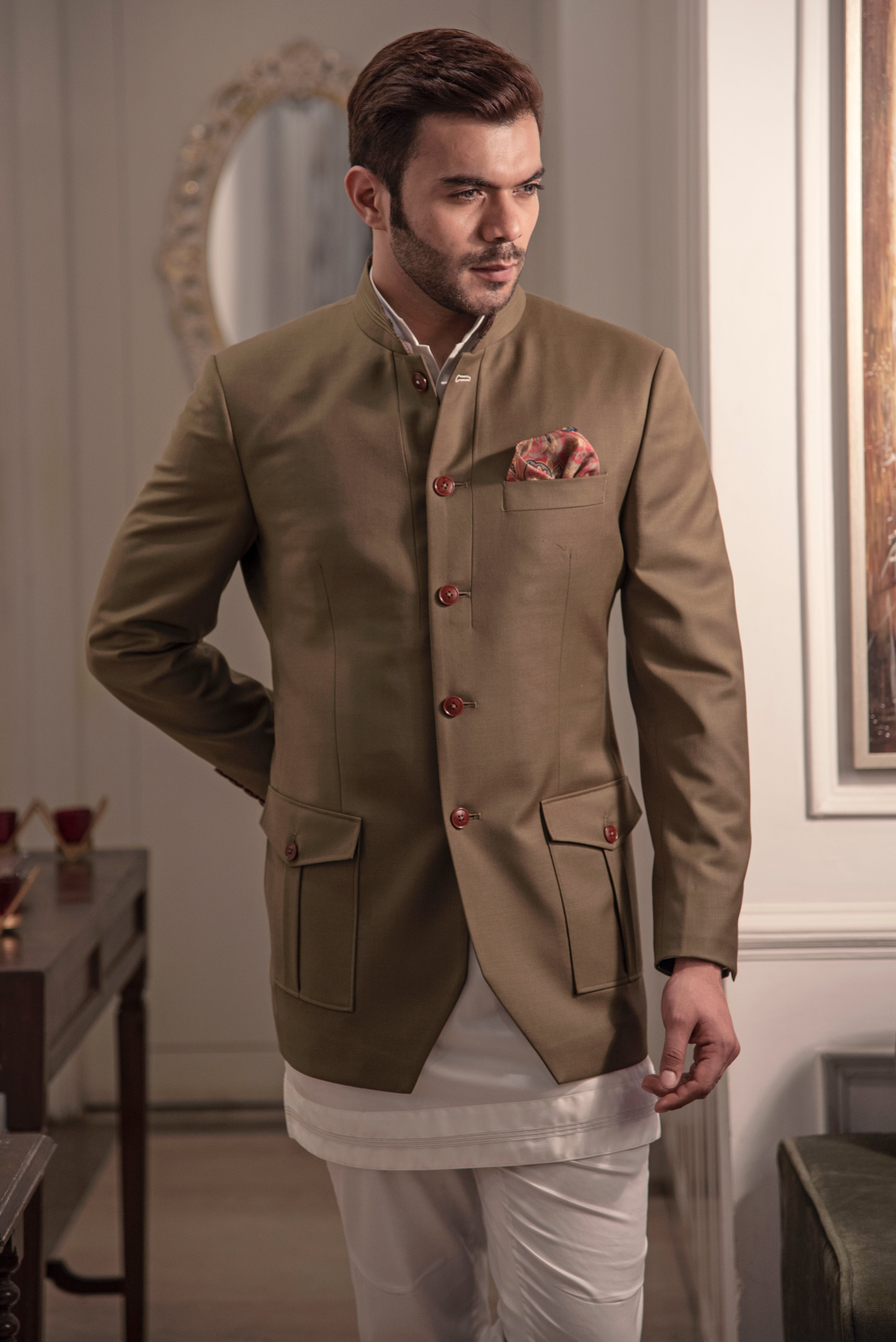 Olive coloured, safari look bandgala jacket. Paired up with off white short kurta and pant cut pajama.