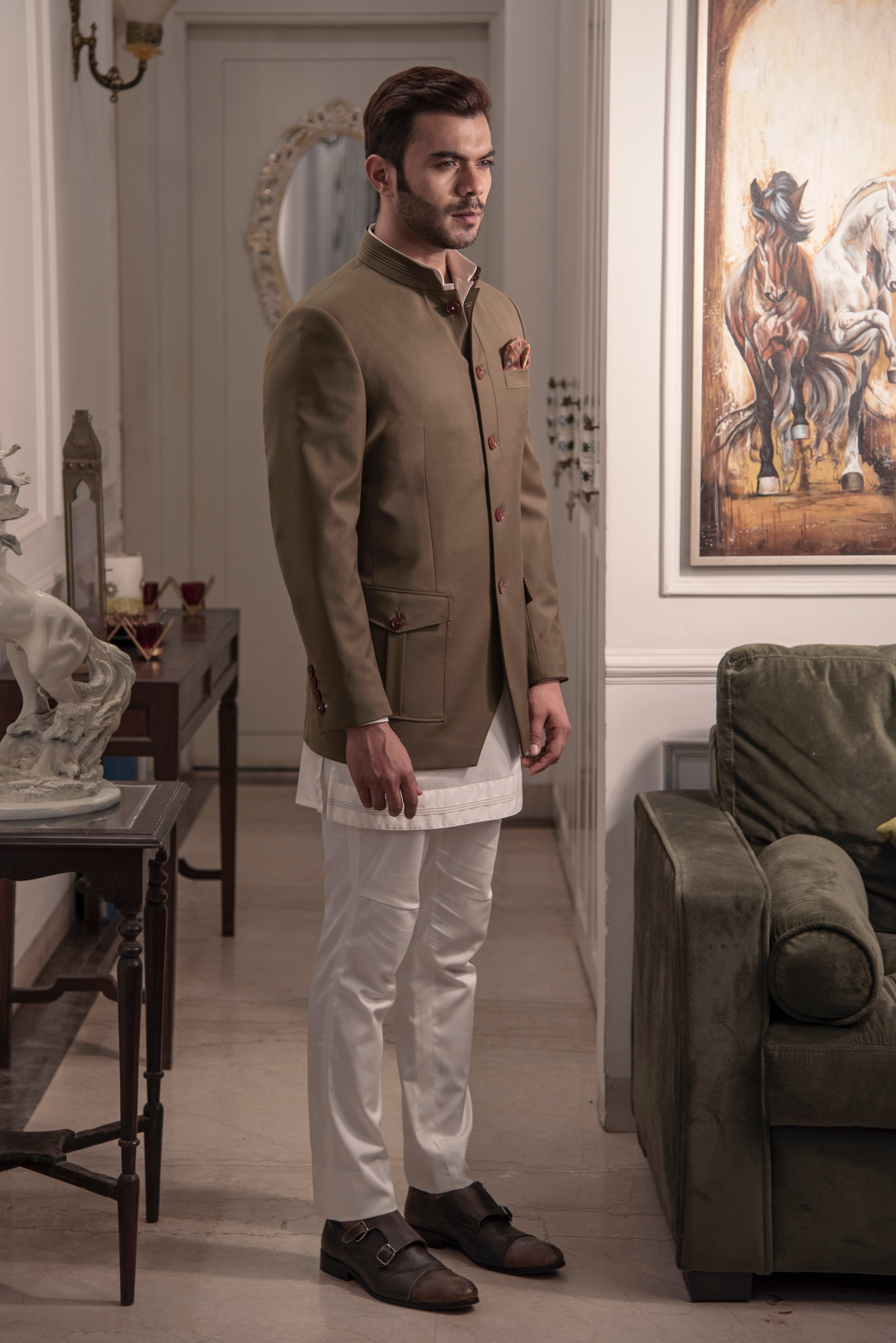 Olive coloured, safari look bandgala jacket. Paired up with off white short kurta and pant cut pajama.