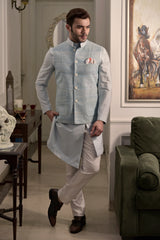 Powder blue raw silk nehru jacket with designer light blue kurta and ivory pant pajama.