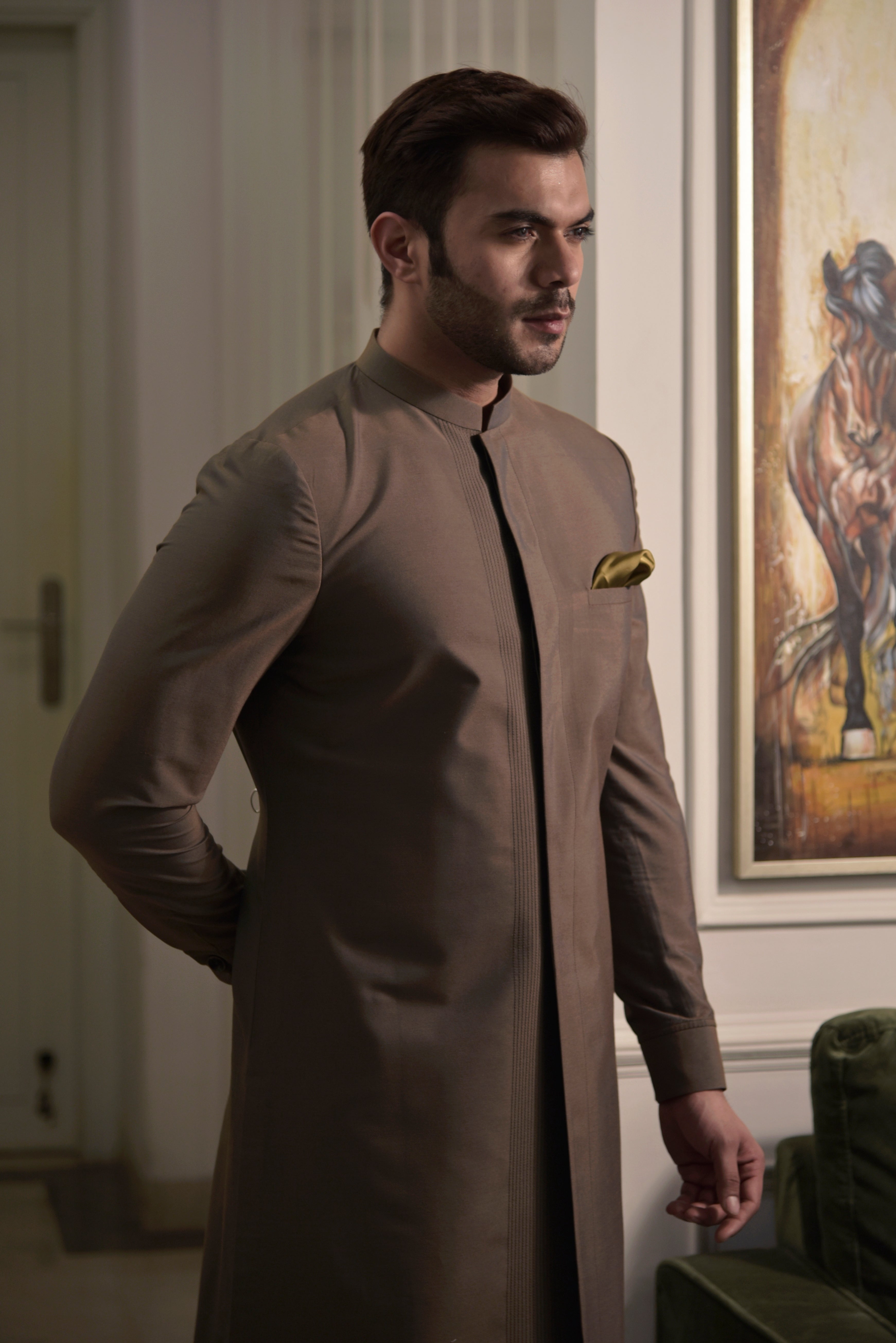 Brown sherwani cut kurta.  Paired up with ivory pant cut pajama.