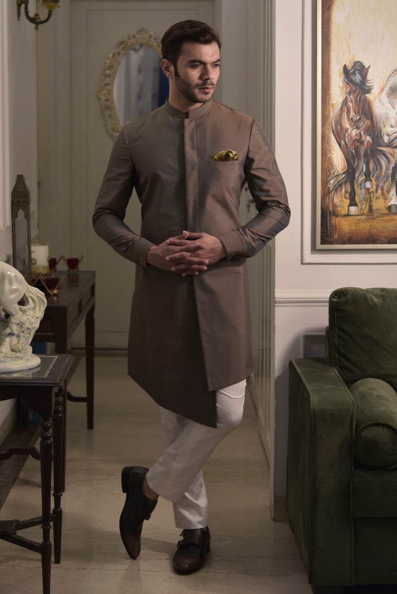 Brown sherwani cut kurta.  Paired up with ivory pant cut pajama.