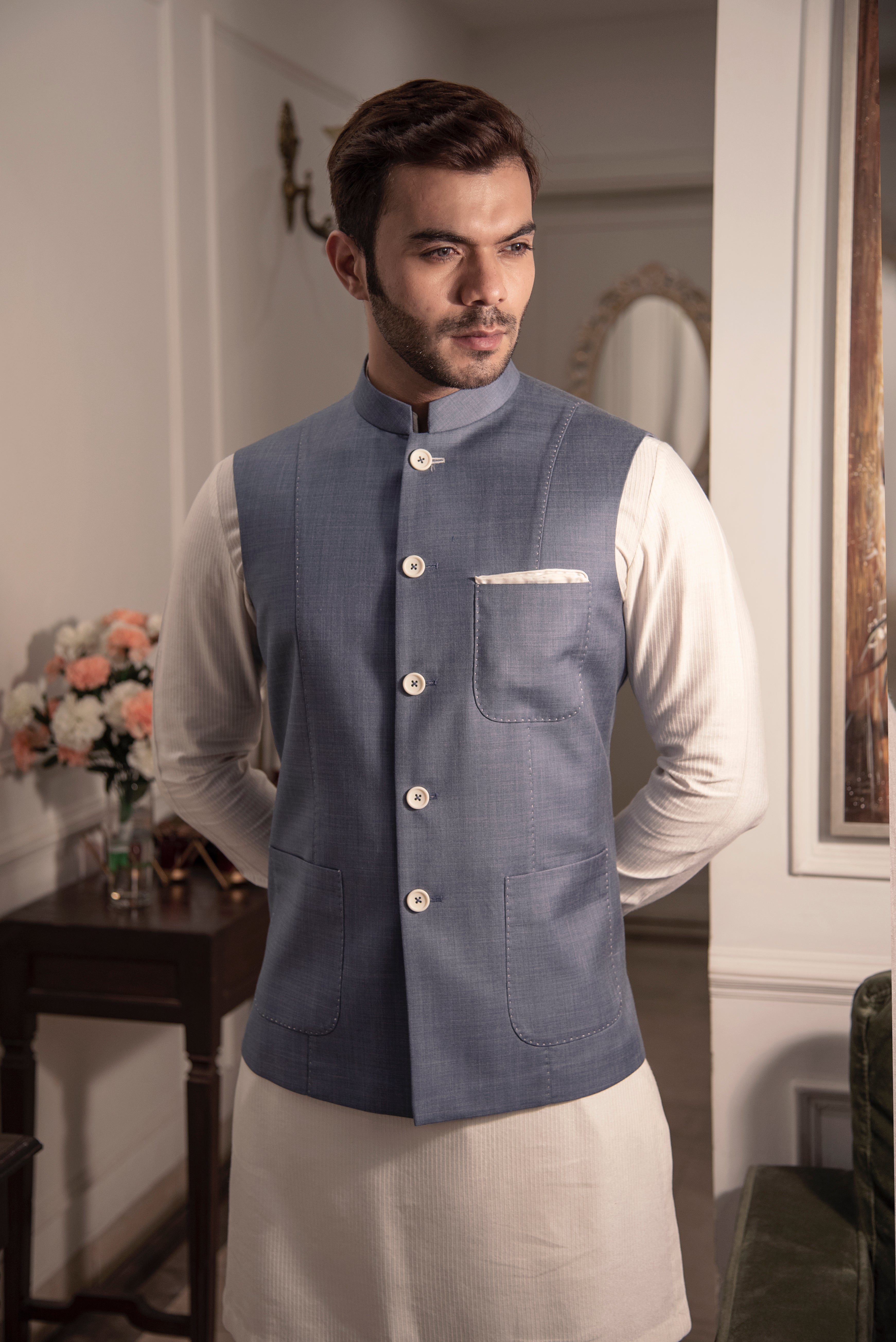 Greyish blue nehru jacket with off white kurta pajama.