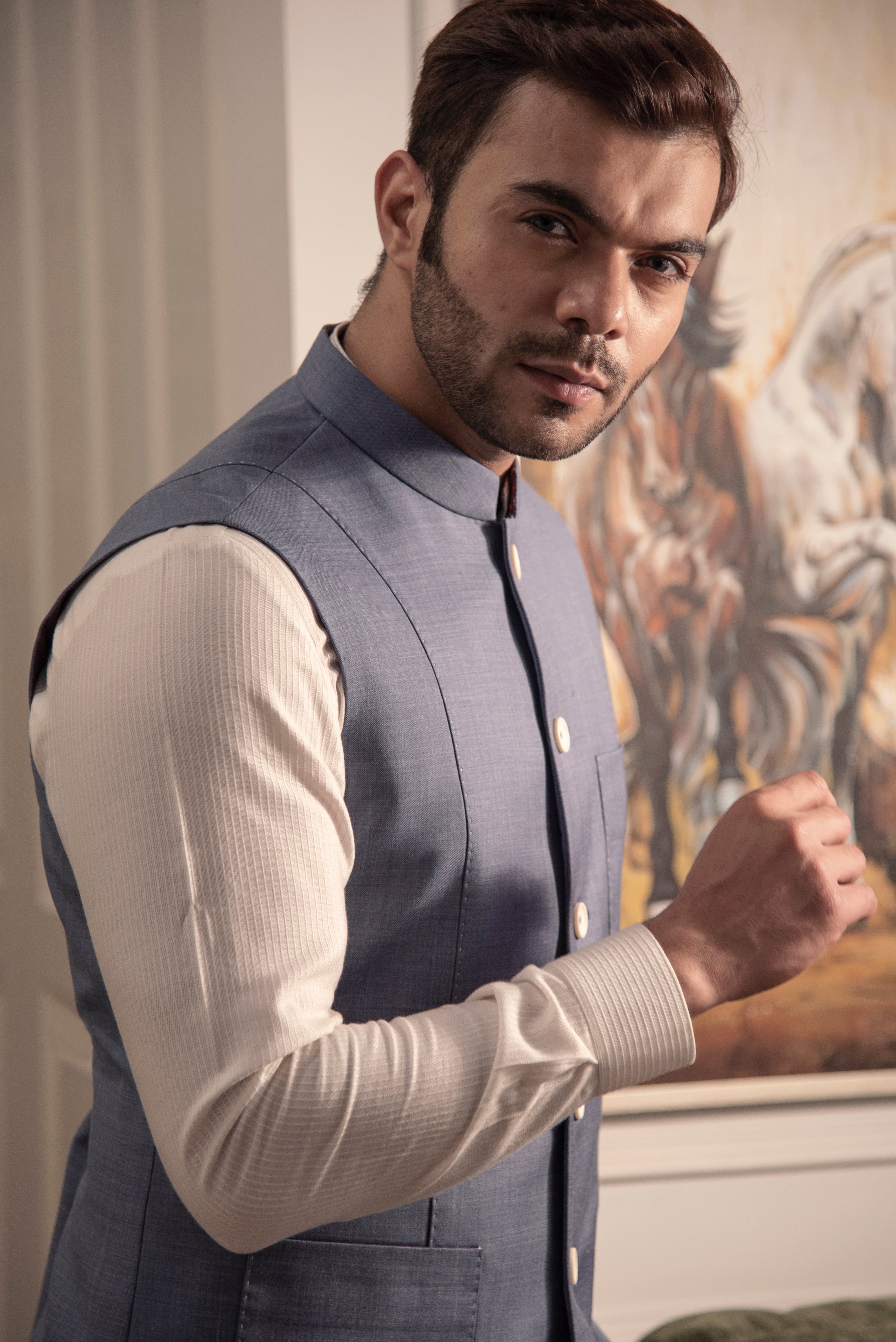 Greyish blue nehru jacket with off white kurta pajama.