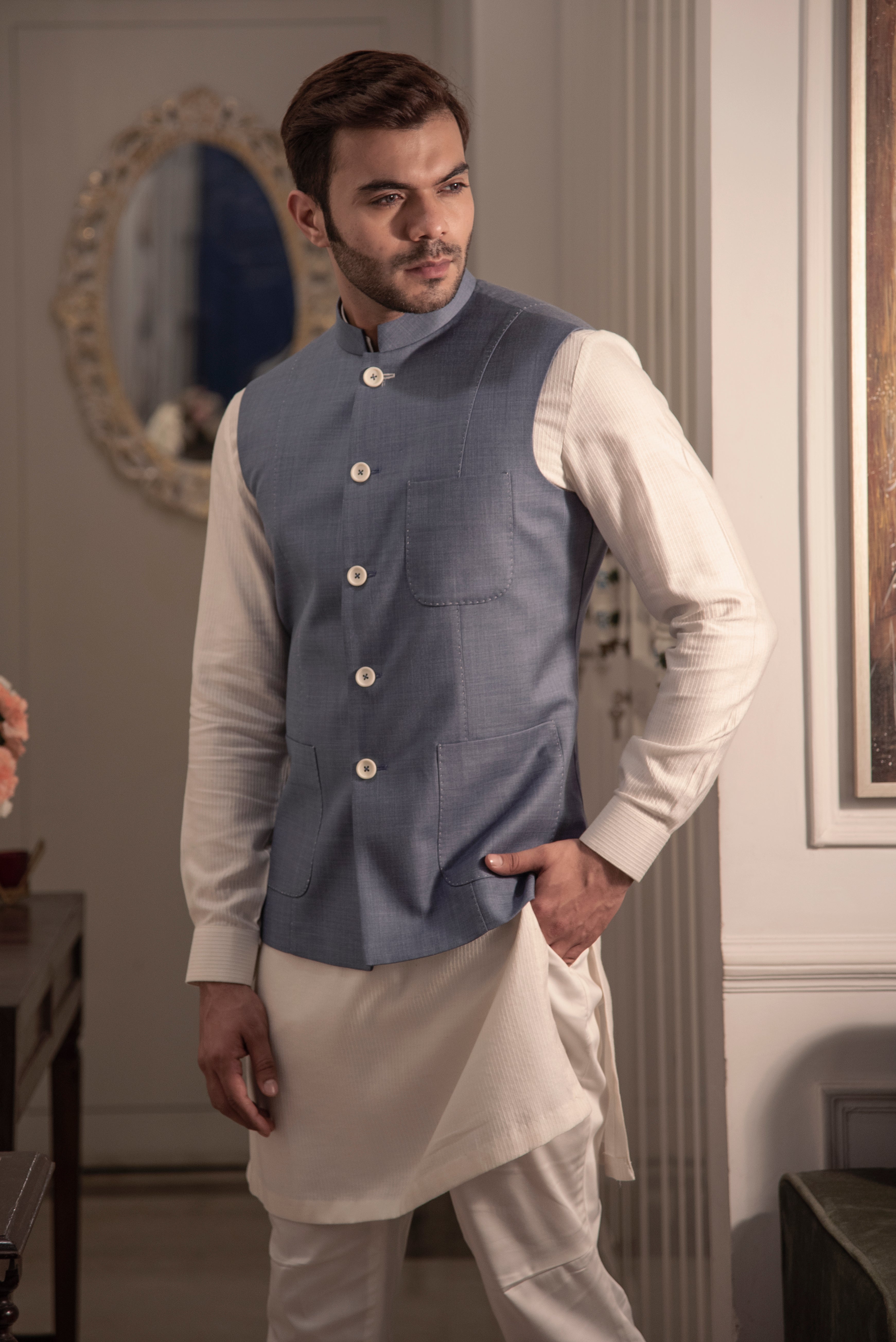 Greyish blue nehru jacket with off white kurta pajama.