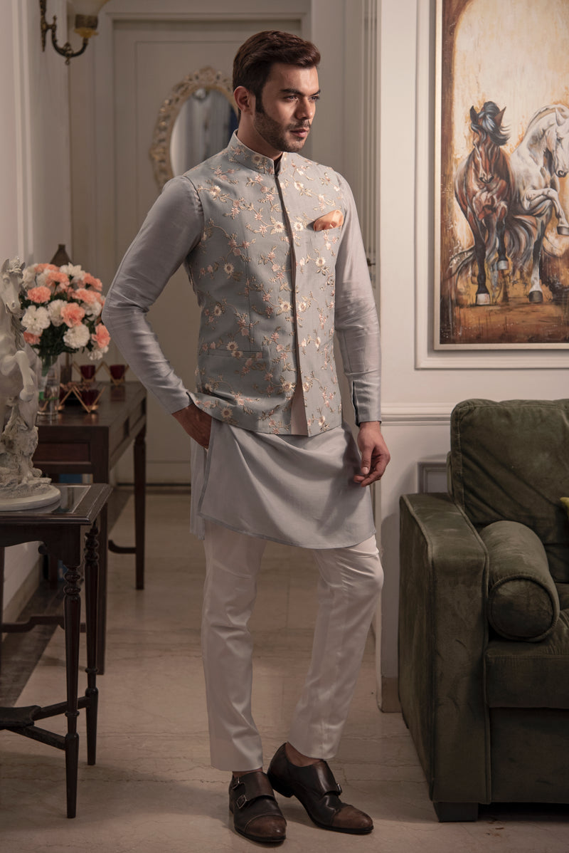 Grey embroidered nehru jacket with grey coloured kurta and off white pant pajama.