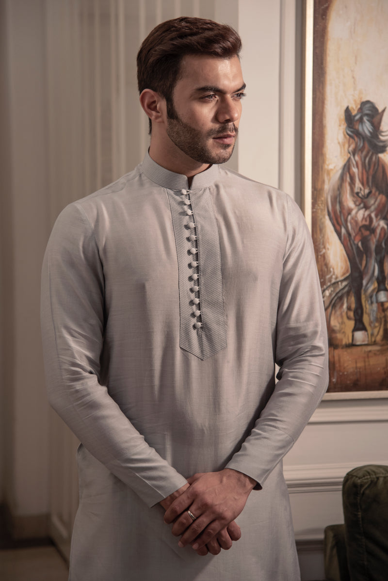 Classic grey kurta in silk fabric with loop buttons. Paired up with ivory pant cut pajama.