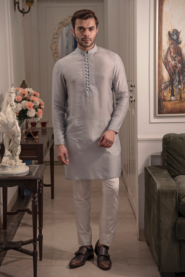 Classic grey kurta in silk fabric with loop buttons. Paired up with ivory pant cut pajama.