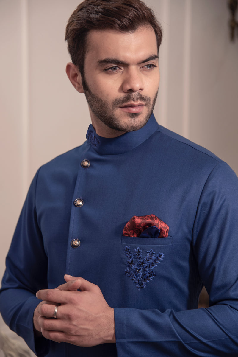 Blue designer indo cut kurta with self blue coloured embroidery. Paired up with ivory pants.