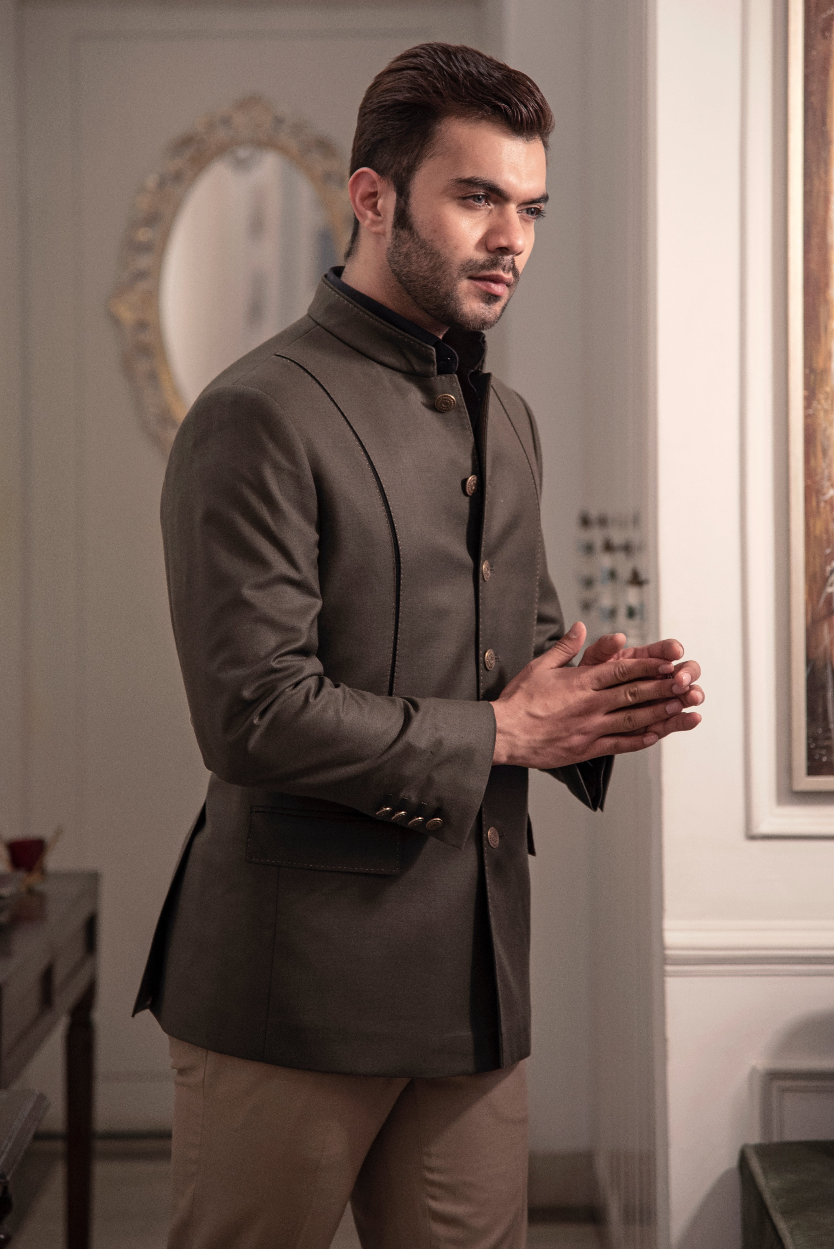 Dark olive coloured designer bandgala jacket. Paired up with beige pants.