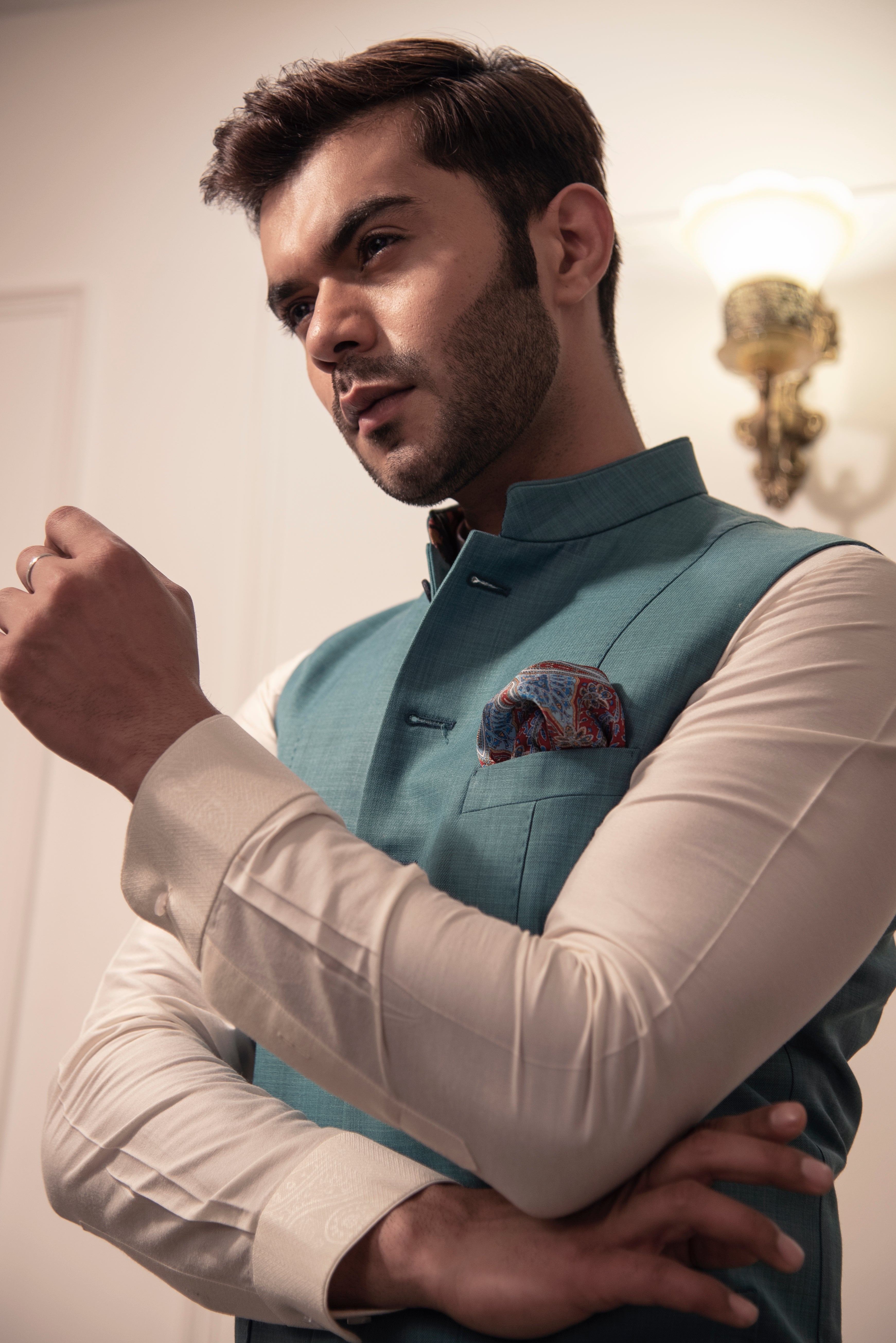 Sea green nehru jacket with off white kurta pajama.