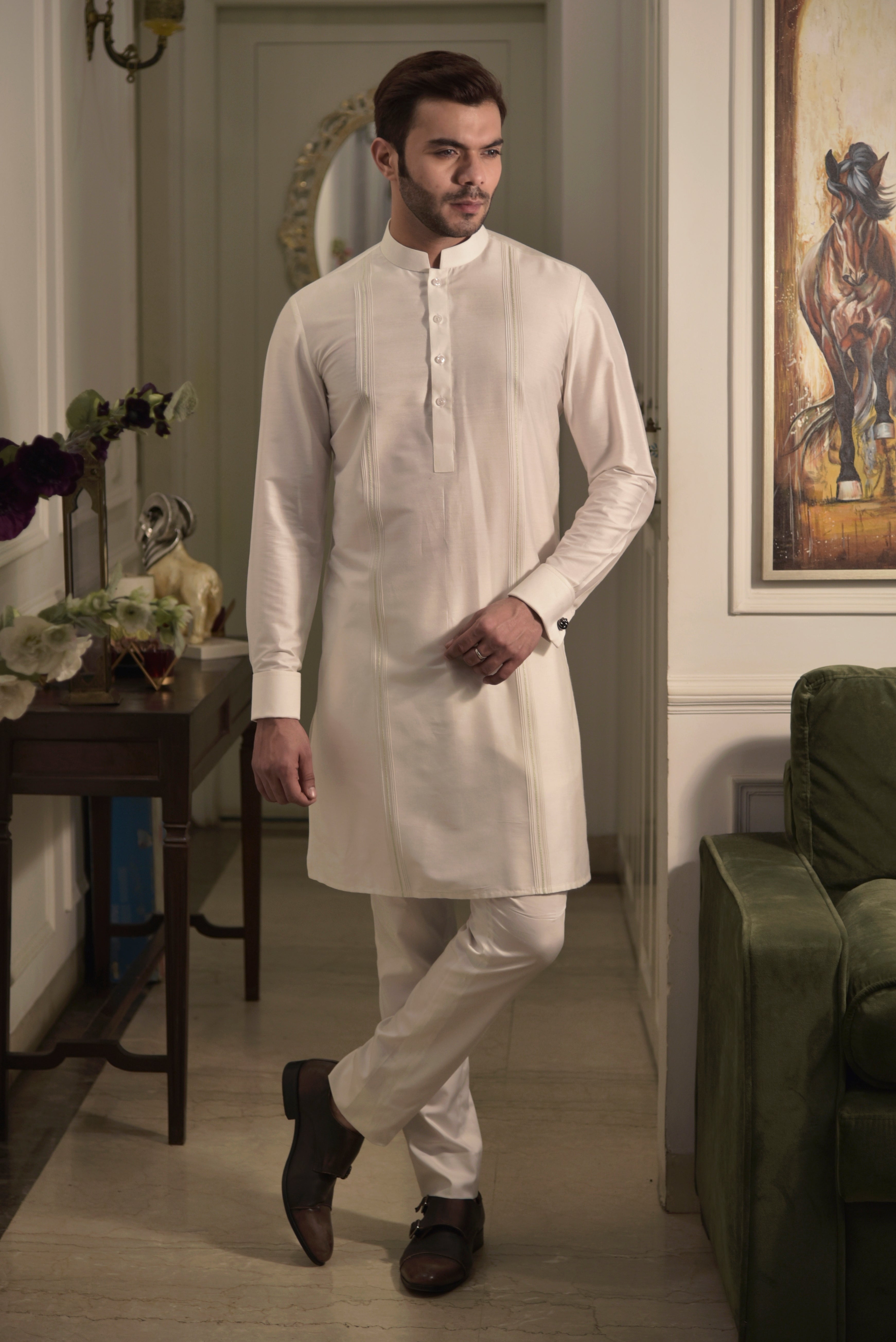 Classic ivory kurta with pin tuck running vertically on the sides. Paired up with ivory pant cut pajama.