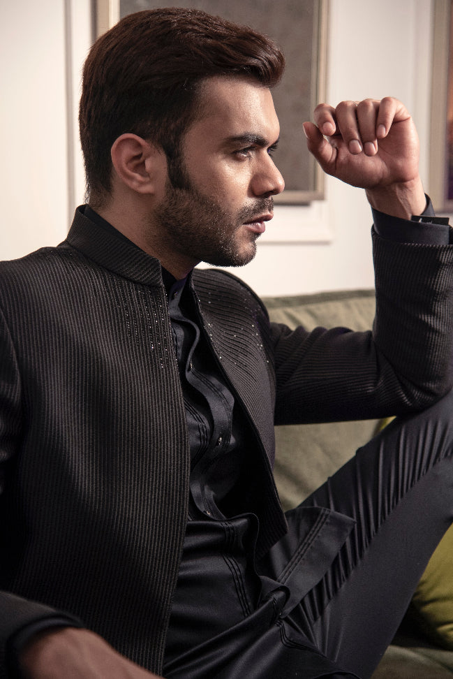 Black open bandgala jacket with pintuck all over and a touch of hand embroidery. Paired up with black long shirt and jet black pants.
