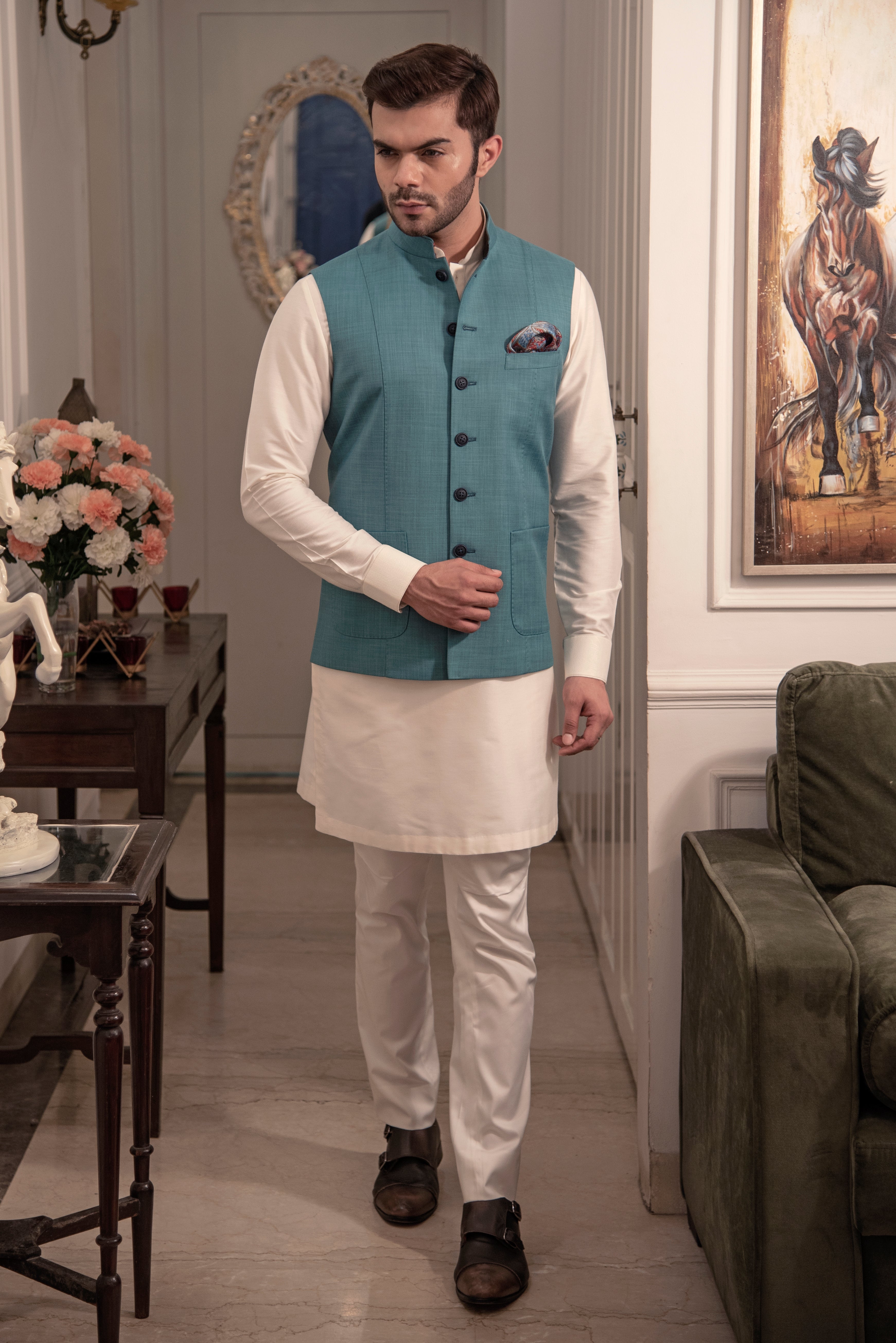 Sea green nehru jacket with off white kurta pajama.